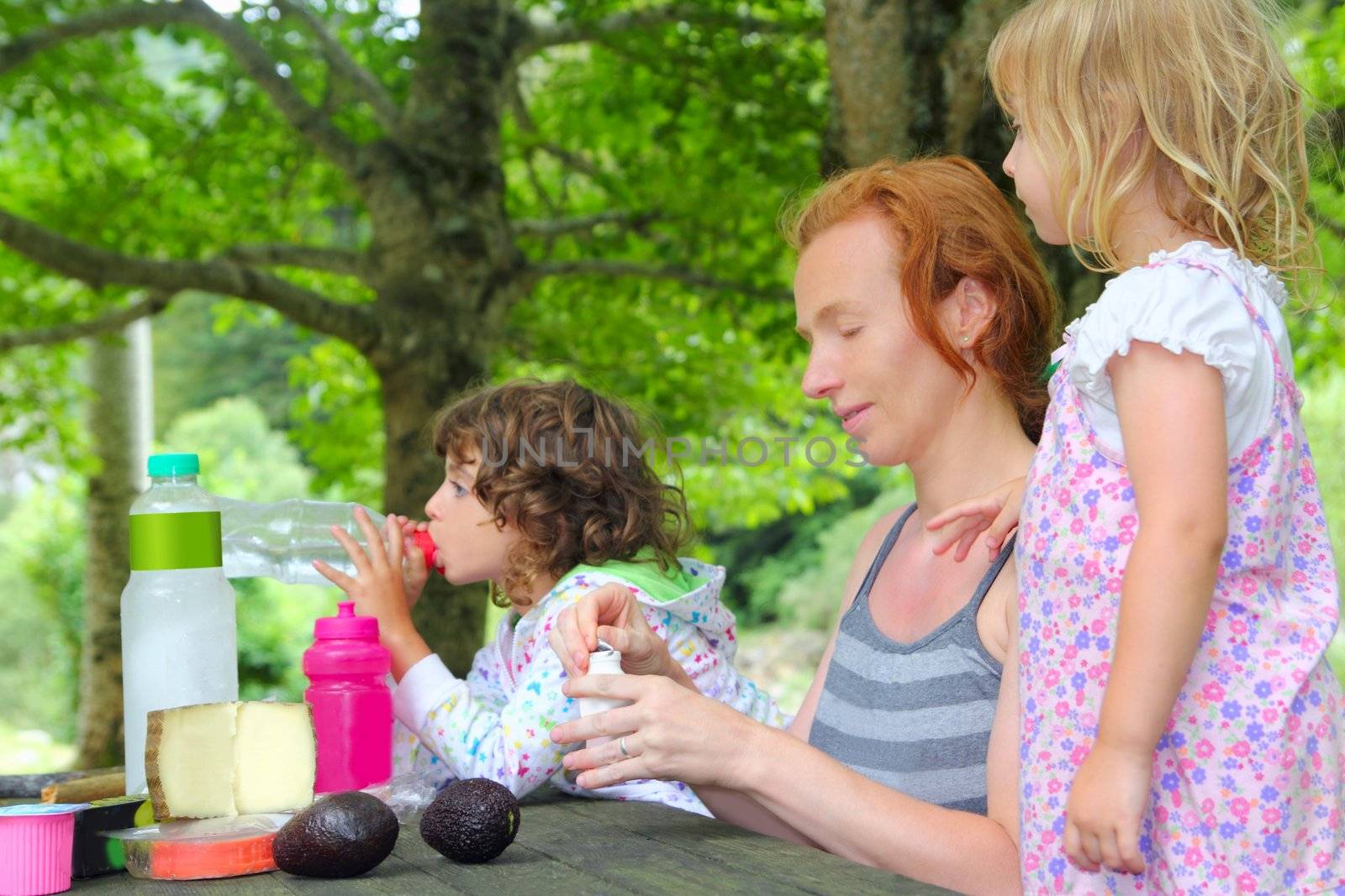 Mother daughter family picnic outdoor park by lunamarina