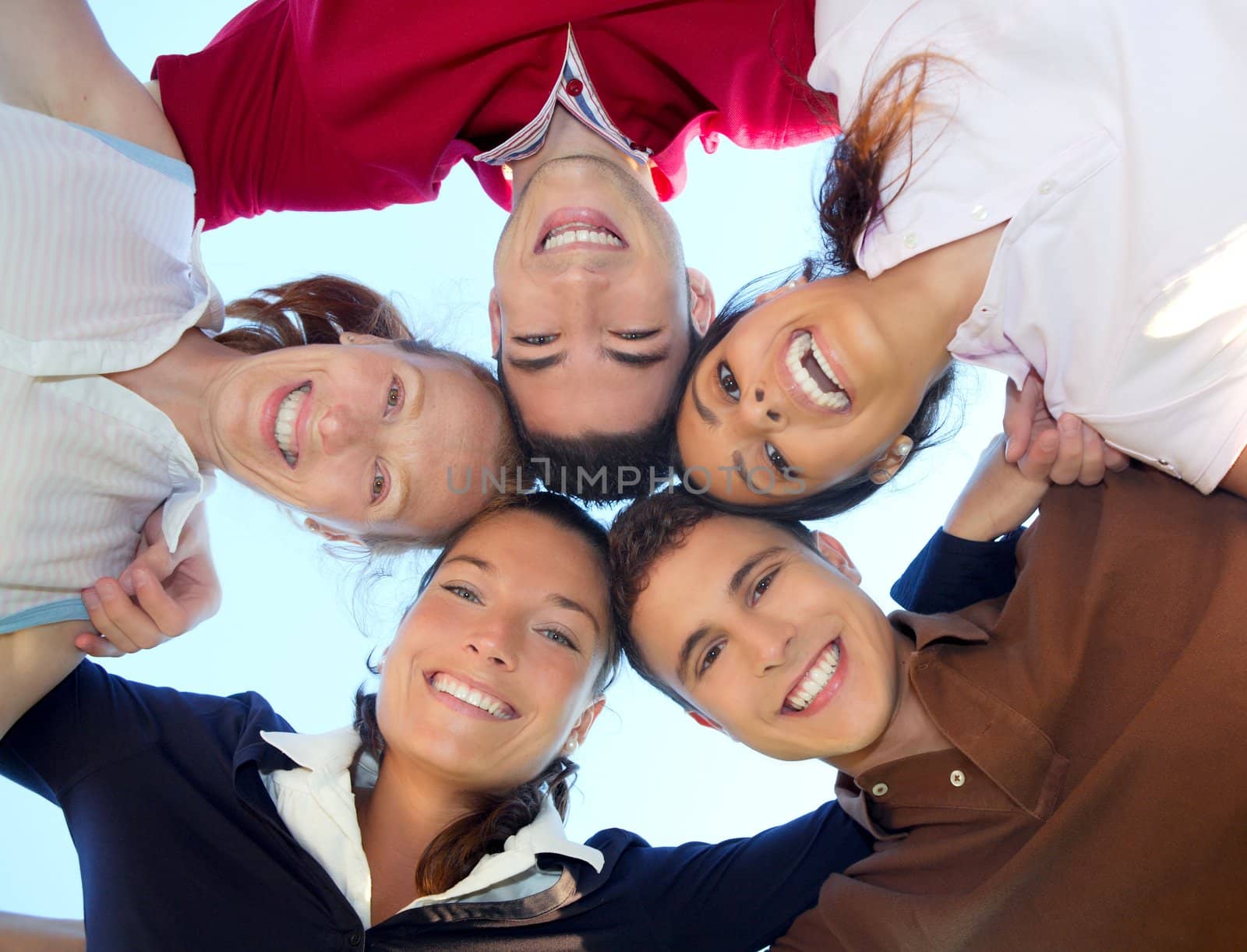 friends happy group in circle heads smiling together from below view