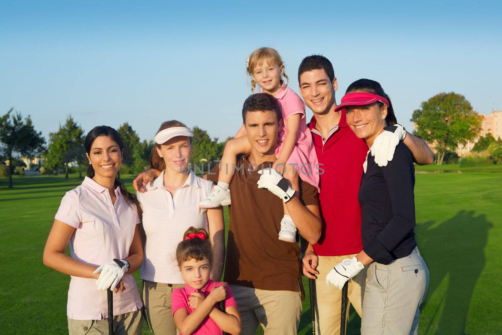 Golf course group of friends people with children by lunamarina