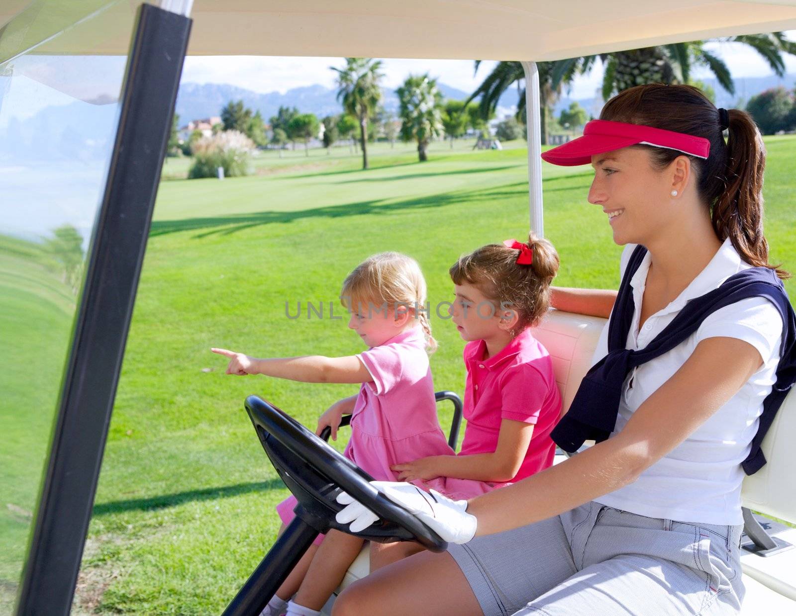 golf course family mother and daughters in buggy by lunamarina