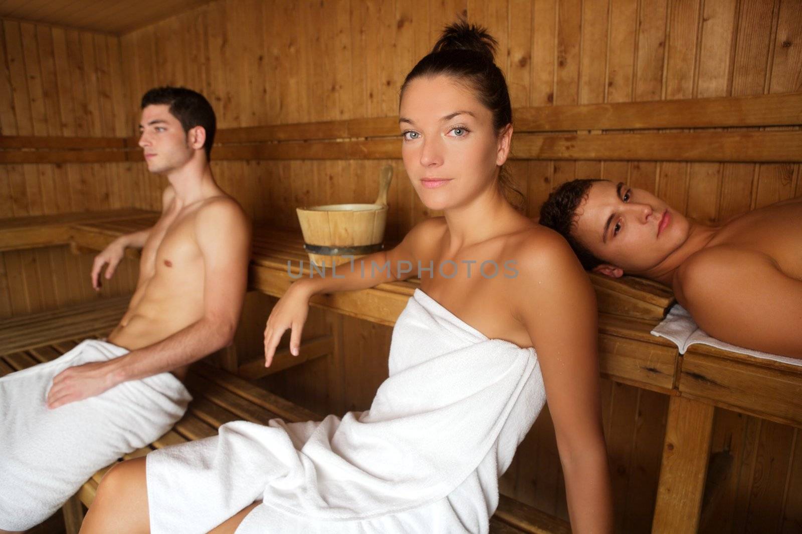 Sauna spa therapy young group in wooden room by lunamarina