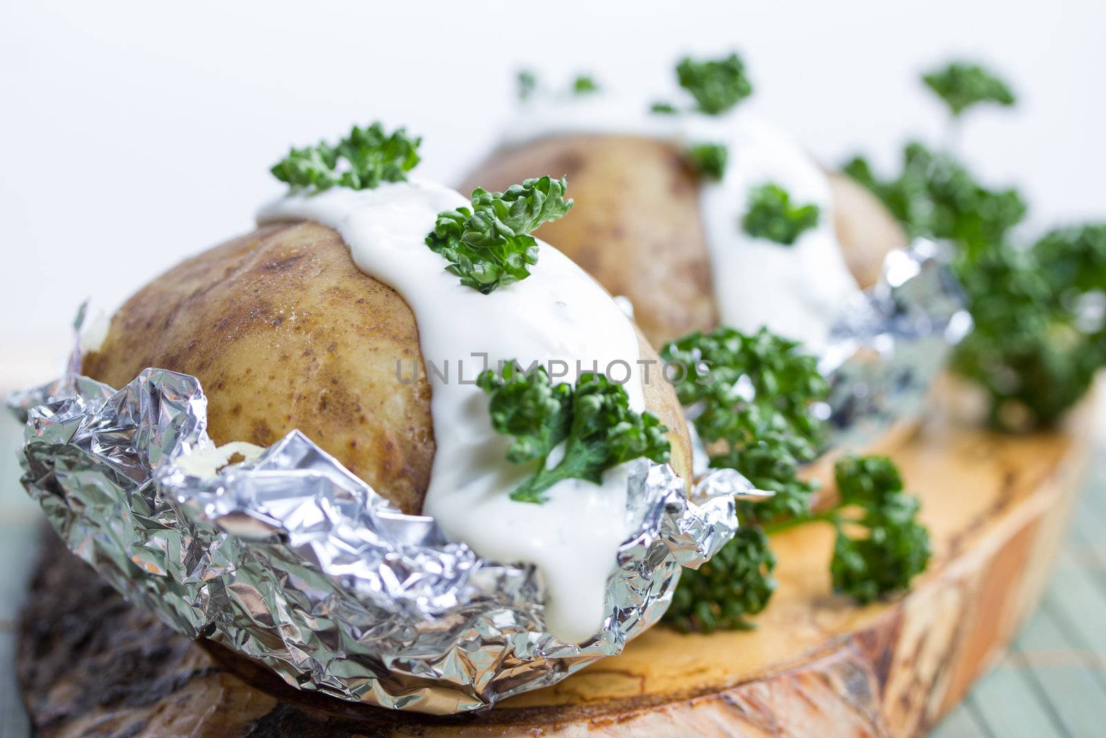 fresh baked potatoe with sour cream by Teka77