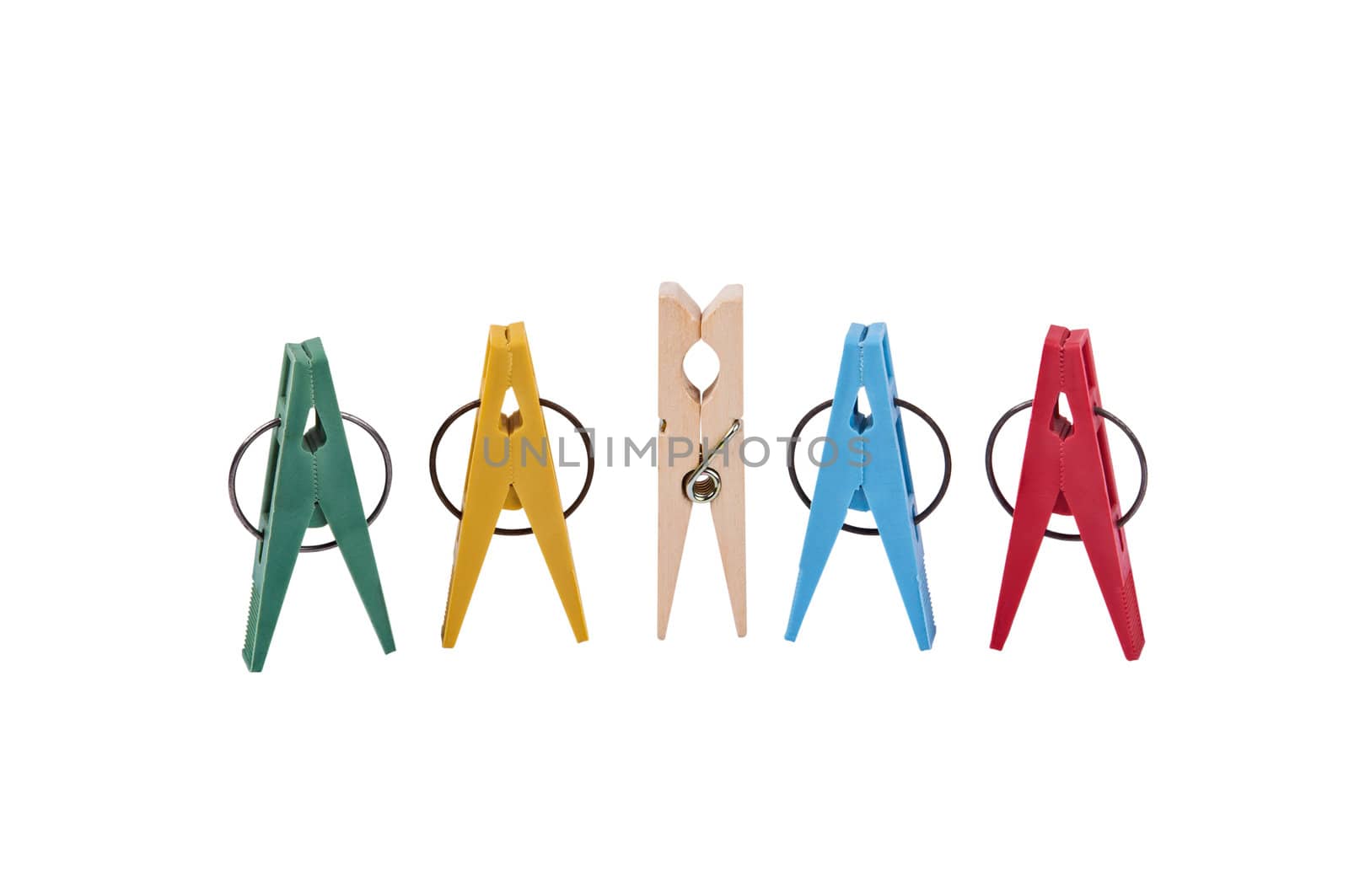 Closeup of five clothespins placed vertically in line. Four clothespins are varicoloured plastic clothespins, in the center is 
a wooden clothespin. Image is isolated on white and the file includes a clipping path.