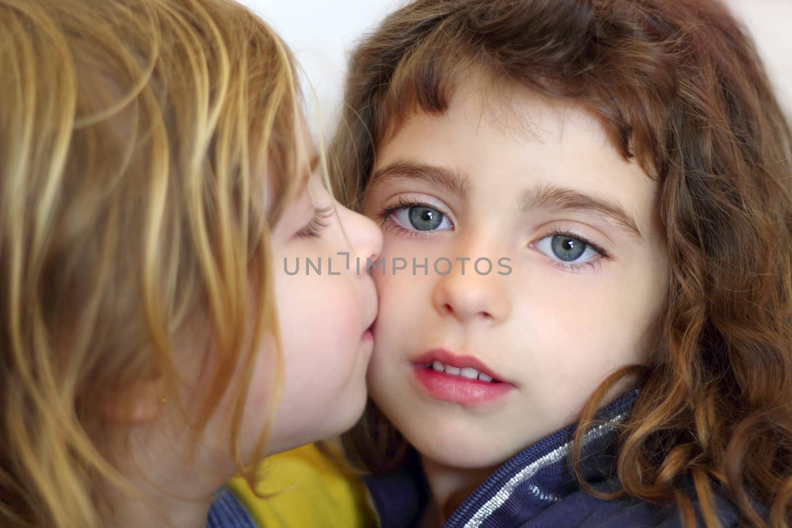 blond little girl kissing her sister blue eyes