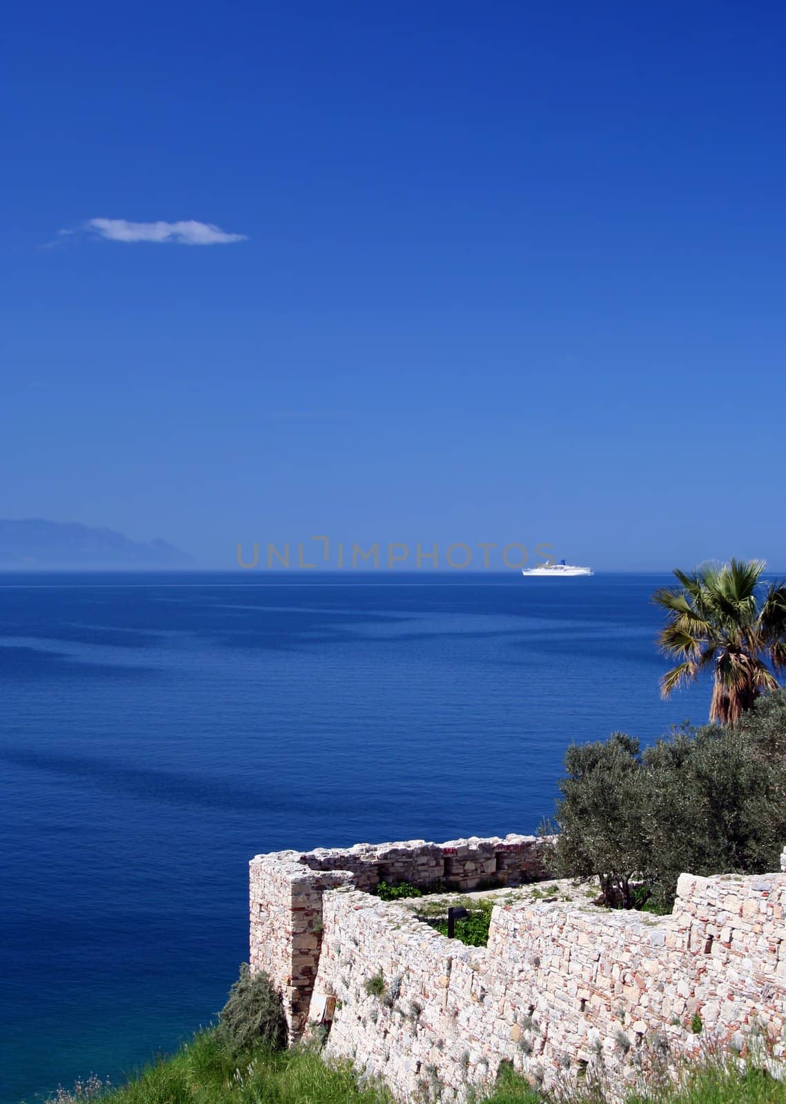 White Cruise Ship Passing by Kusadasi Castle and heading to Samos Island,Greece.