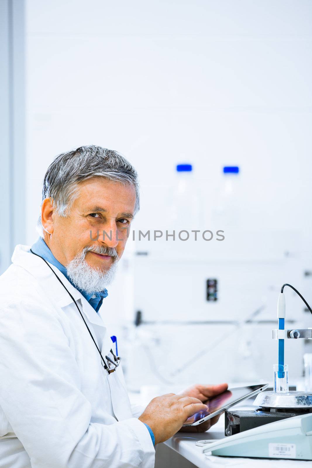 Senior male researcher carrying out scientific research in a lab (shallow DOF; color toned image)