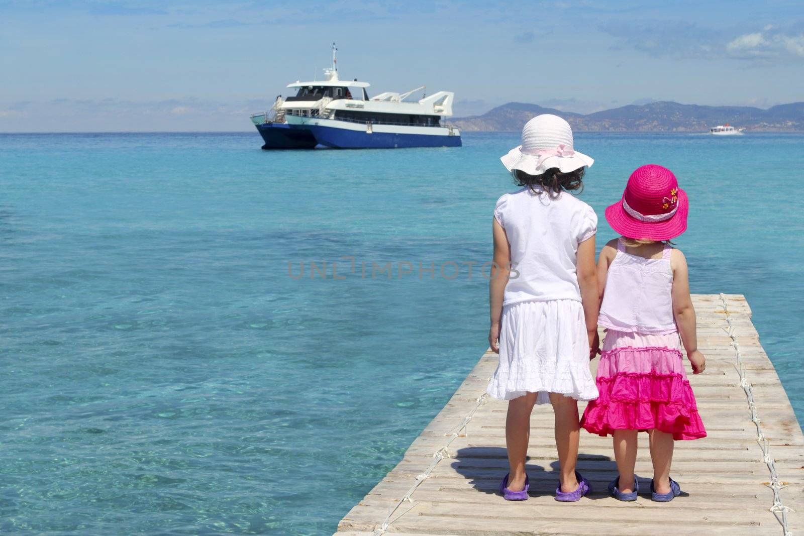 little sisters tourist turquoise sea back in Formentera