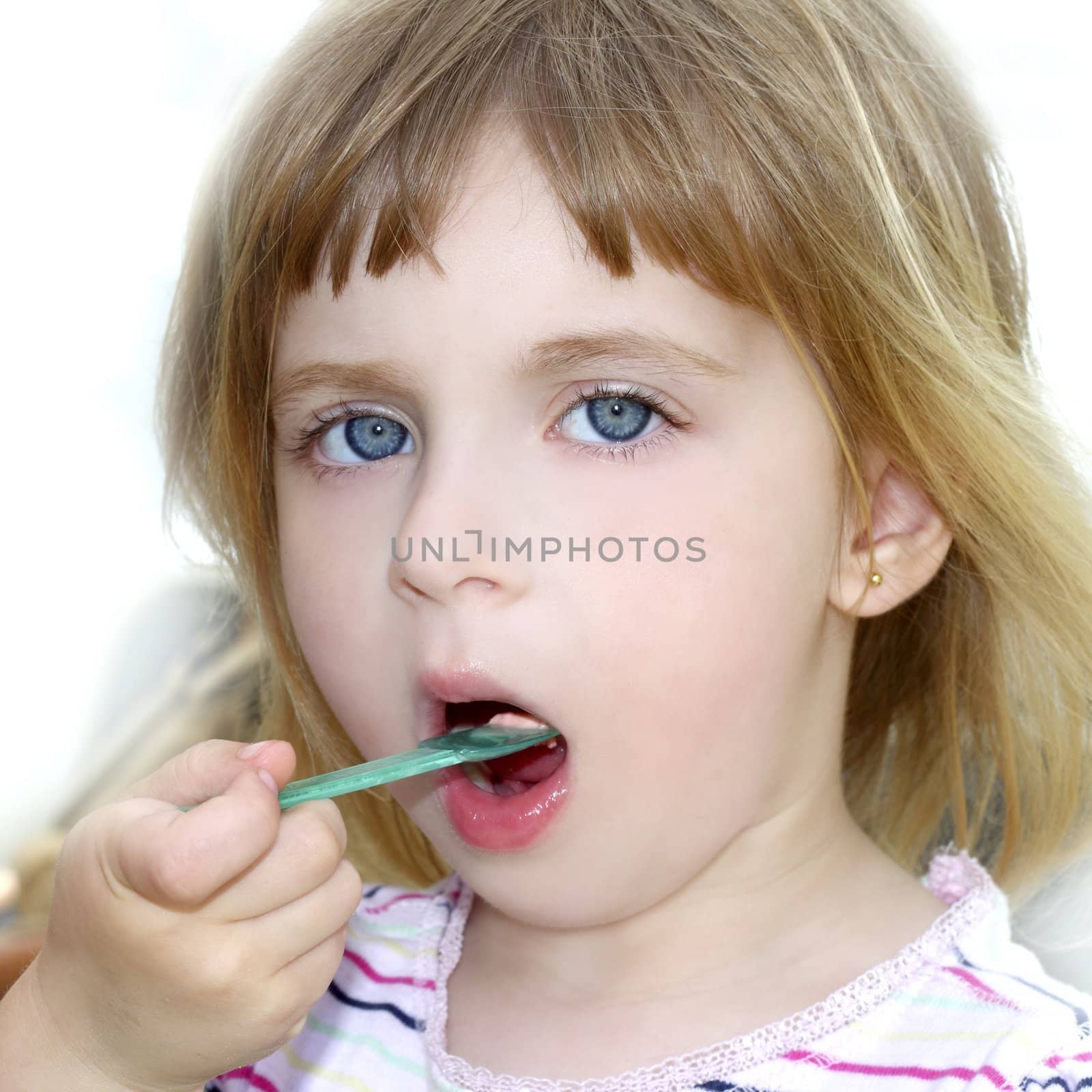 blond little girl eating ice cream color spoon portrait