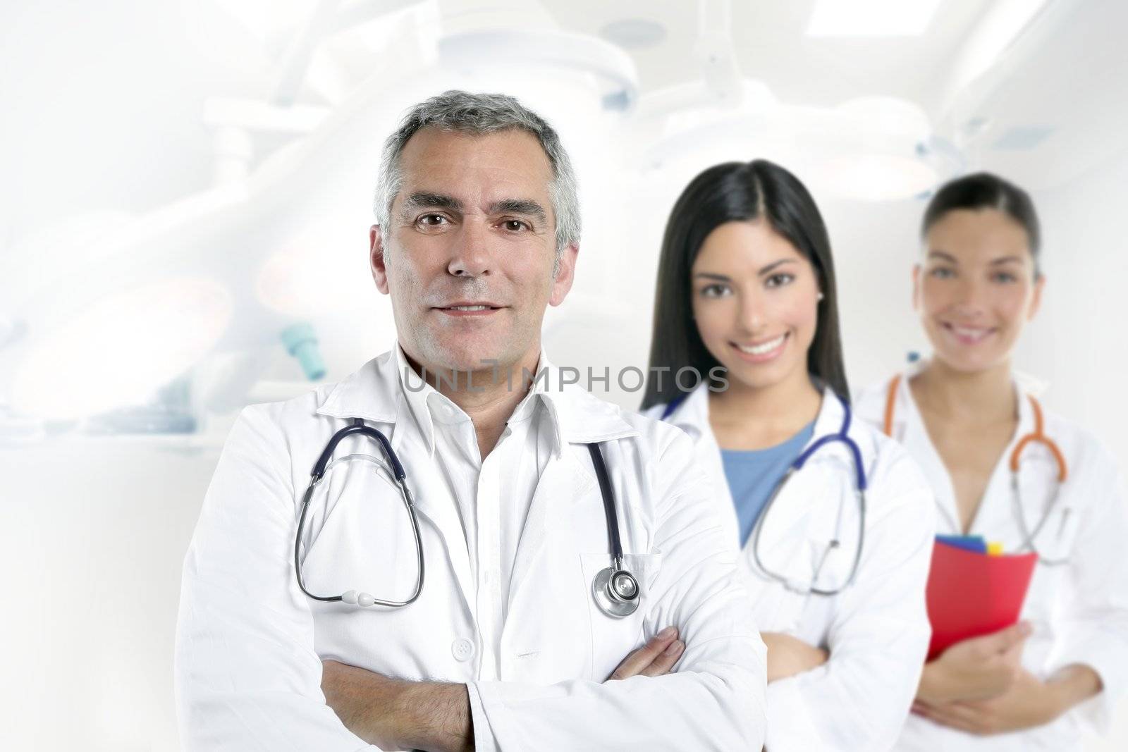 doctor senior expertise gray hair two nurses white hospital