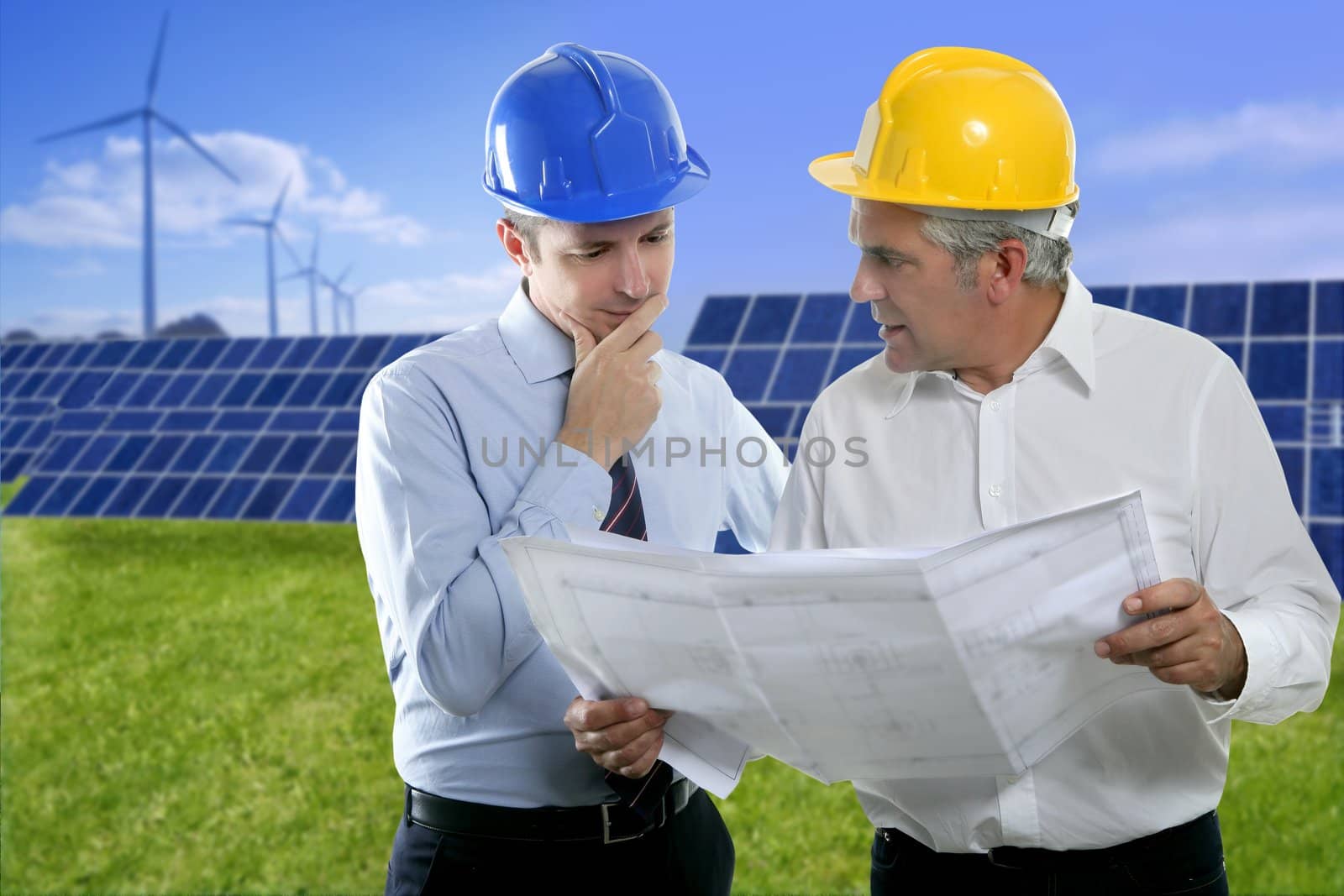 architect engineer two expertise team plan talking hardhat solar plates meadow grass