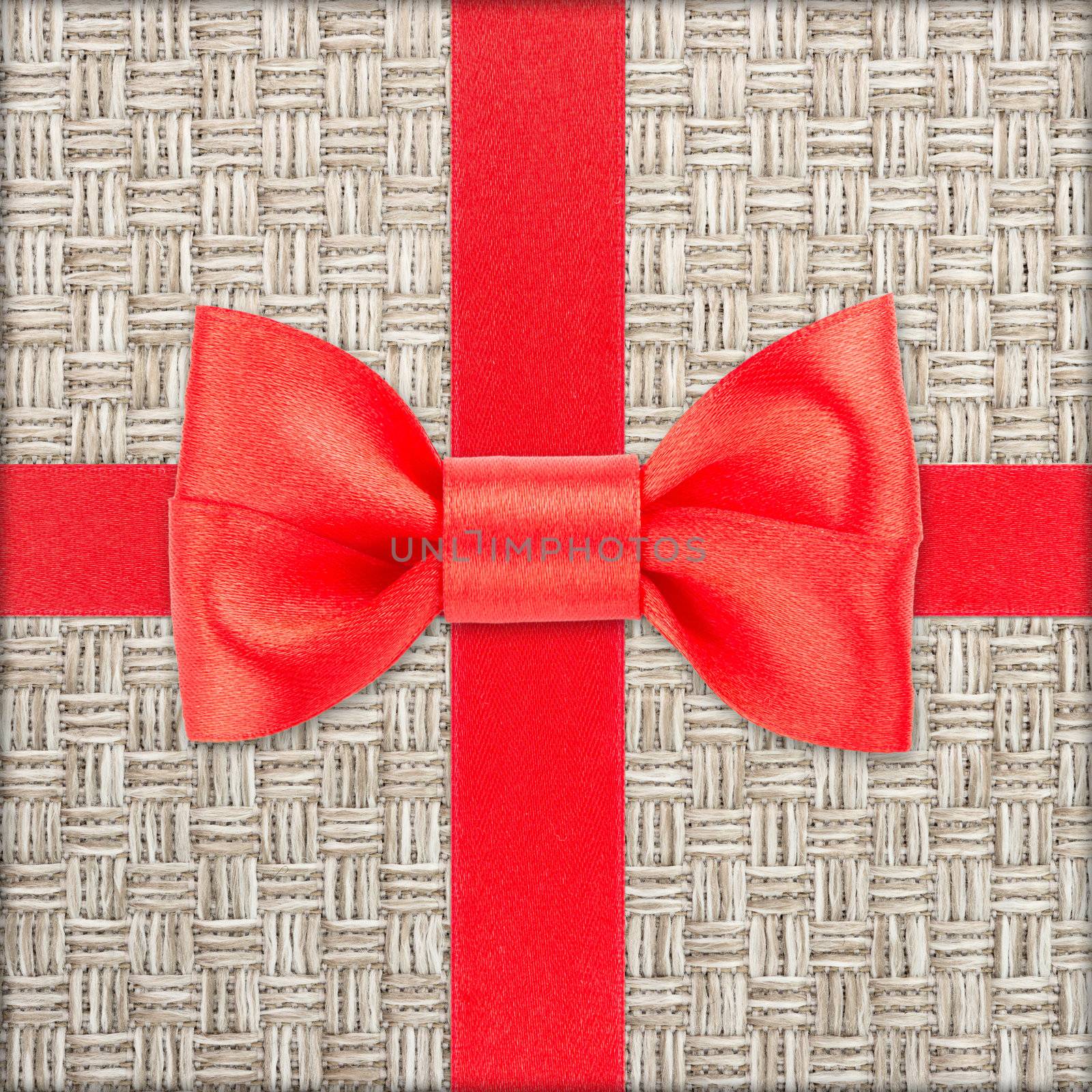 Red bow and ribbon over wrapped gift