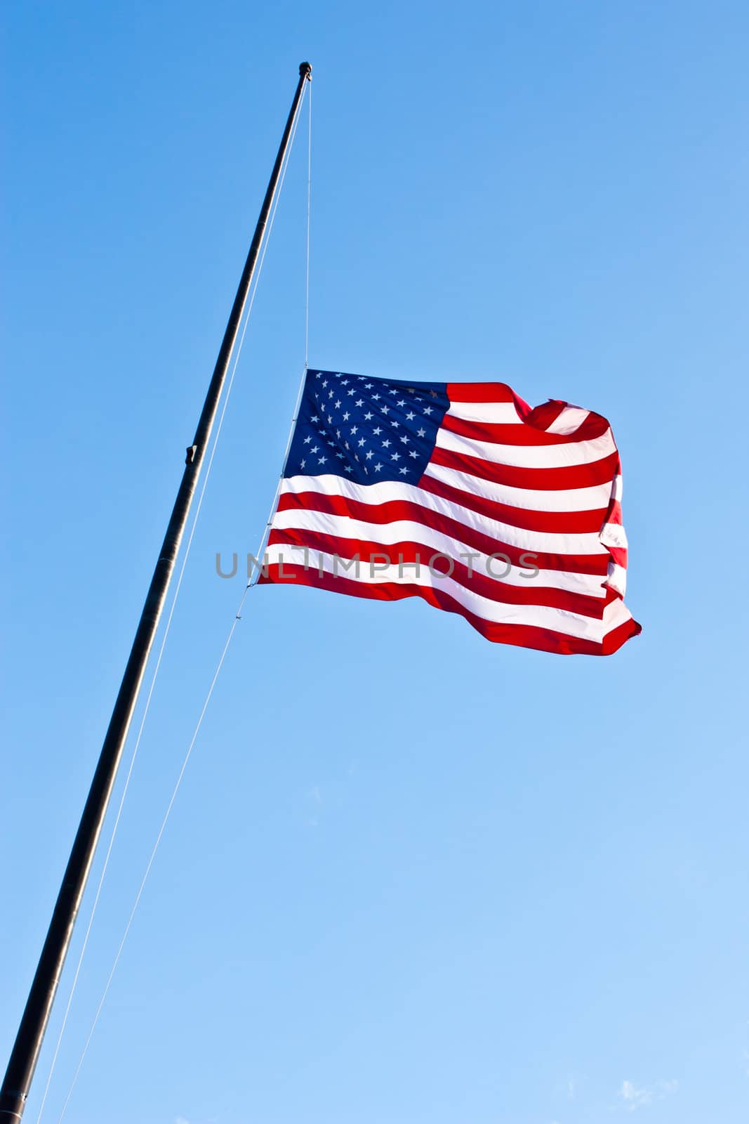 American flag on a blue sky during a windy day