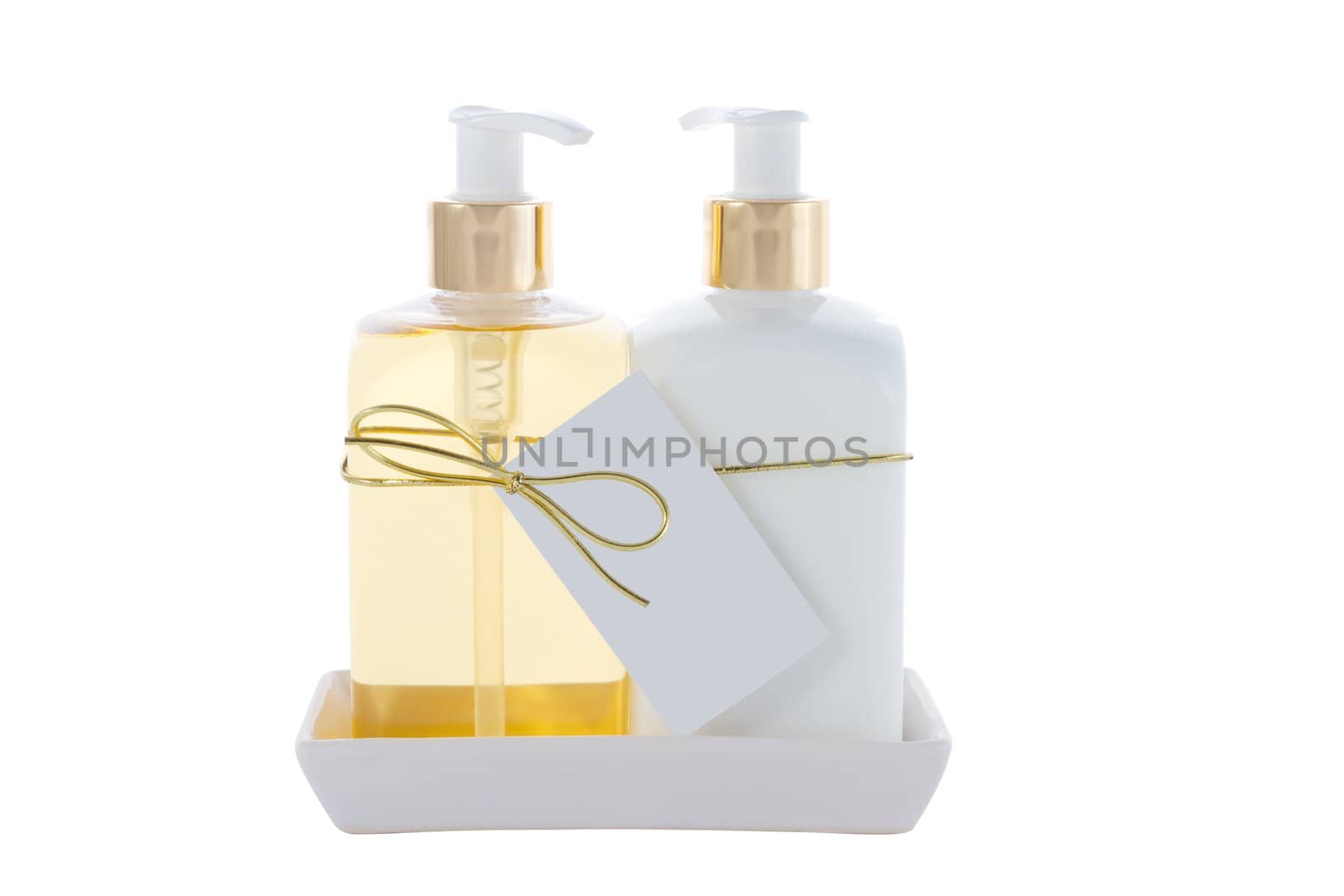 two Hair and Skin care bottles on a stand on a white background