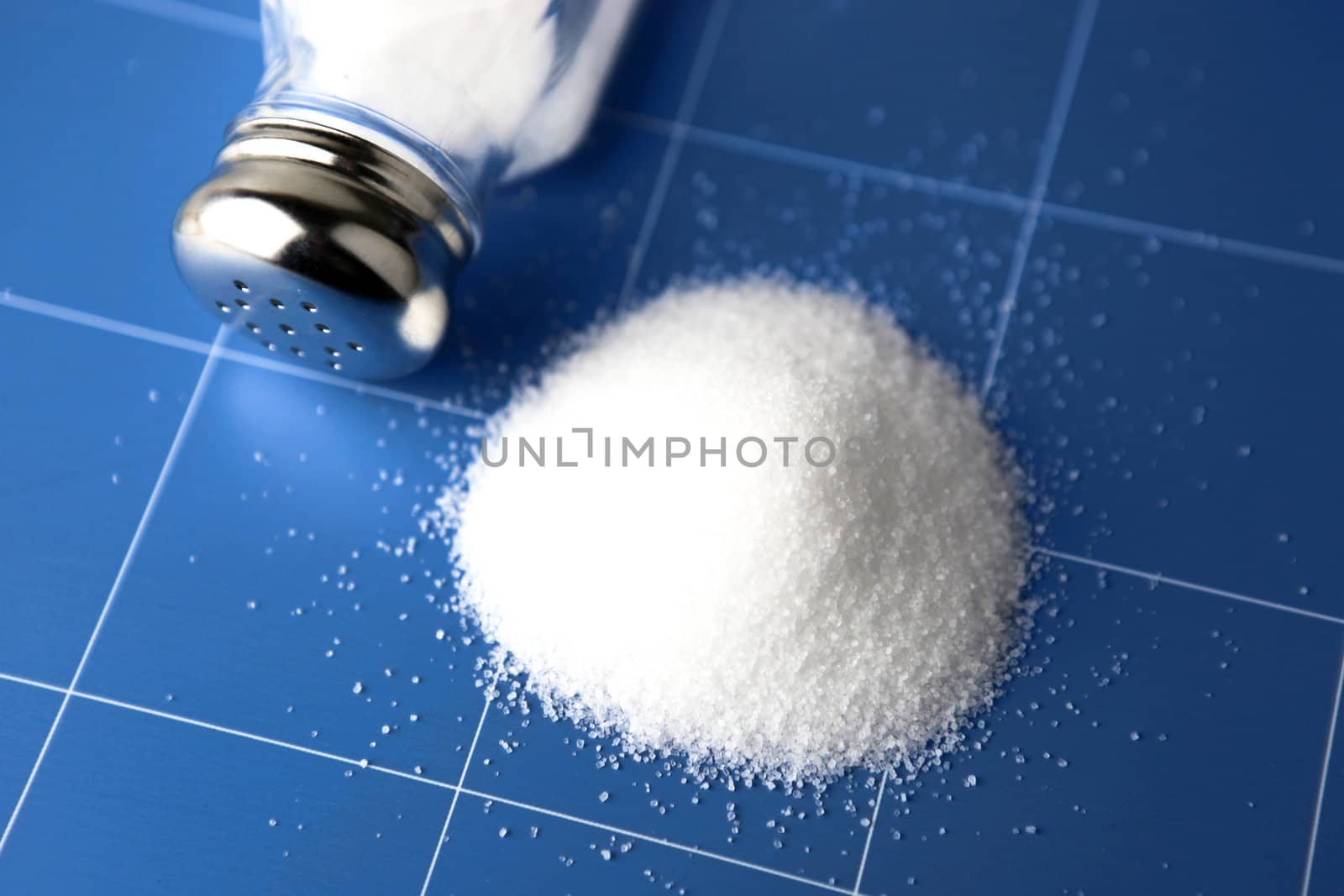 Salt shaker on wooden table