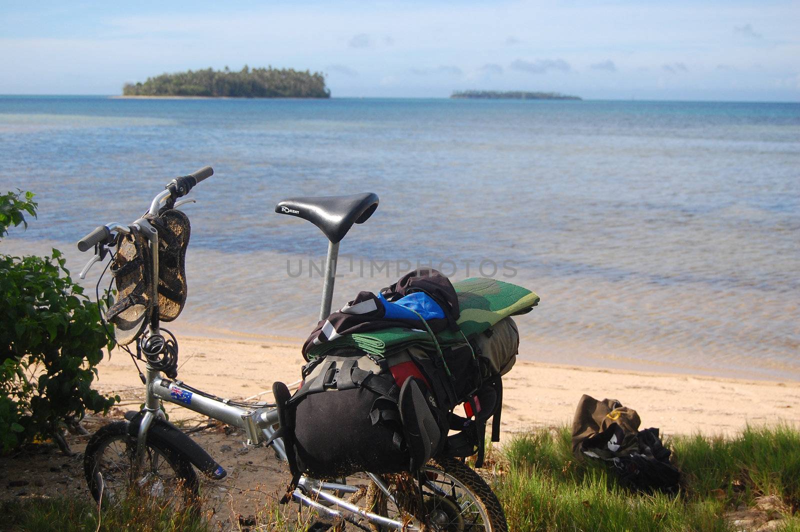 Folding bicycle with backpack on beach by danemo