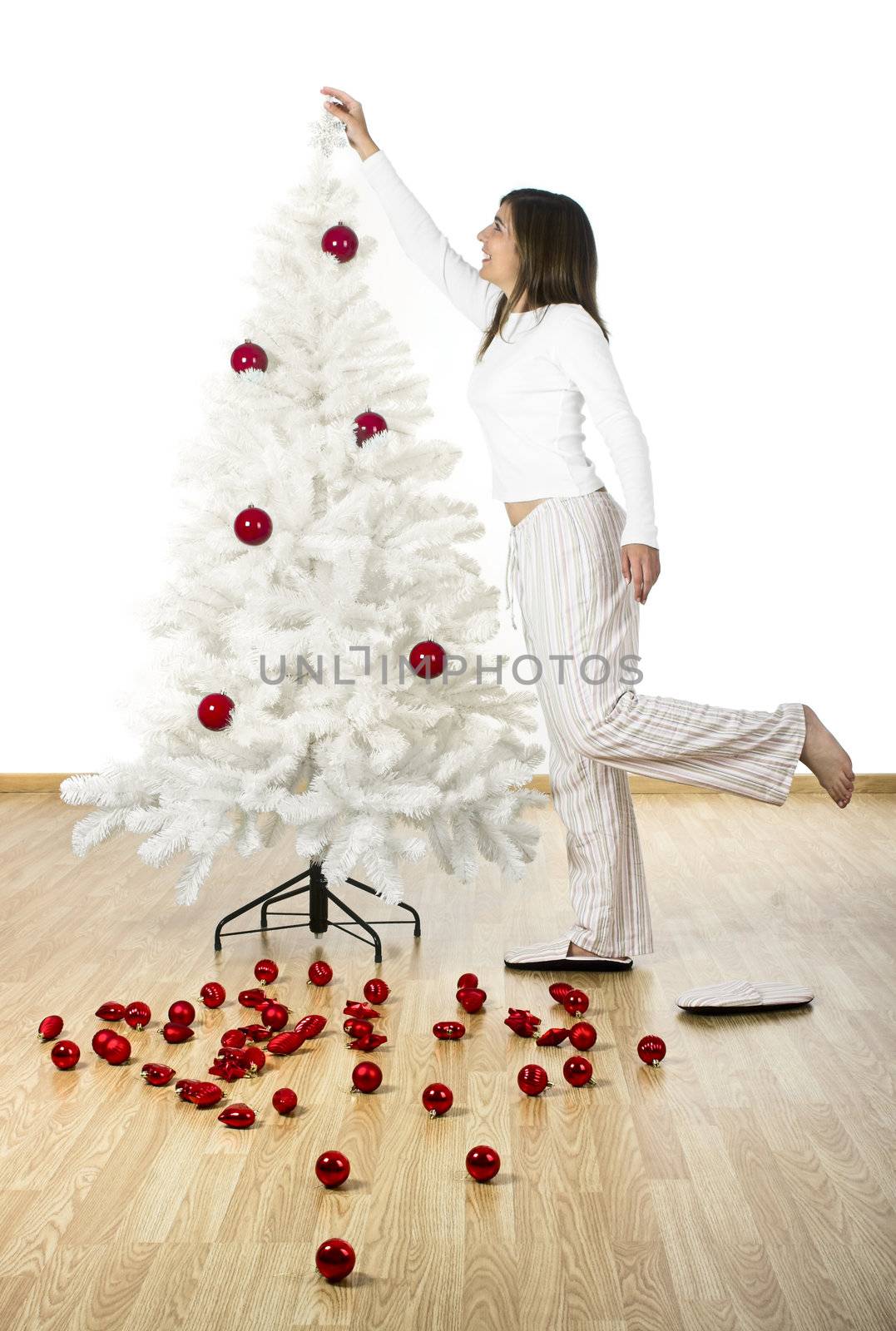 Happy woman on her home decorating a Christmas tree