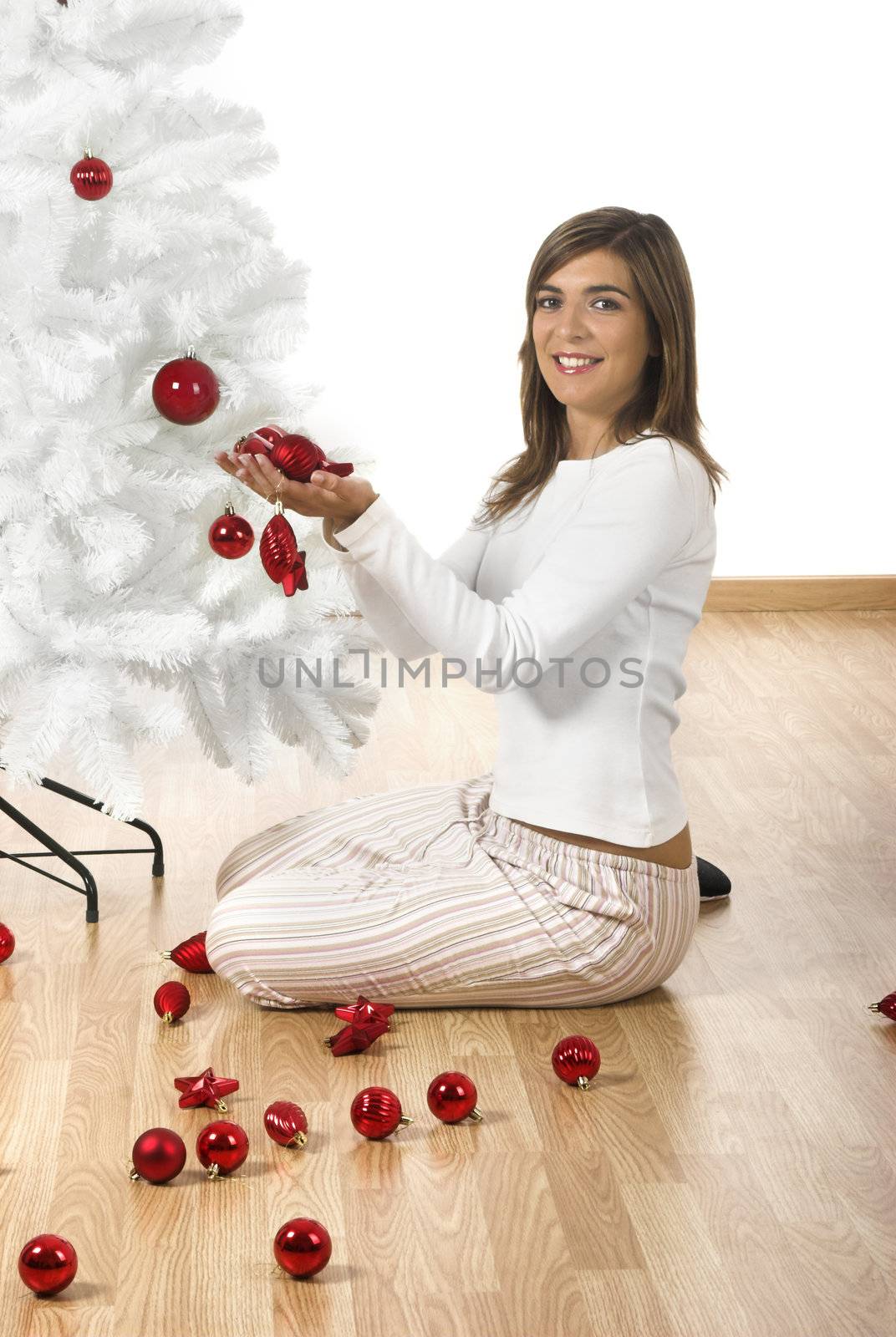 Happy woman on her home decorating a Christmas tree