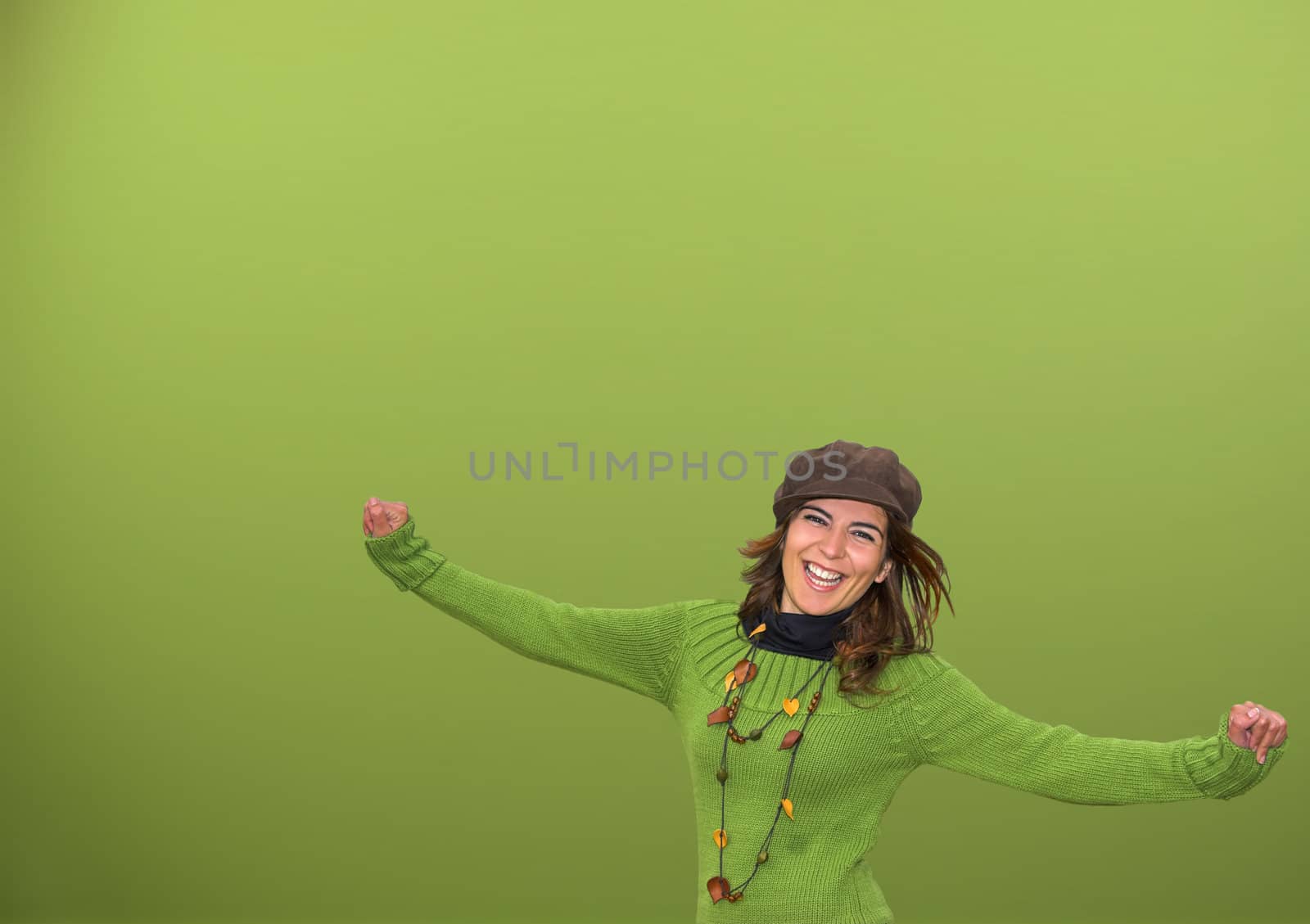 Young happy woman in a green background