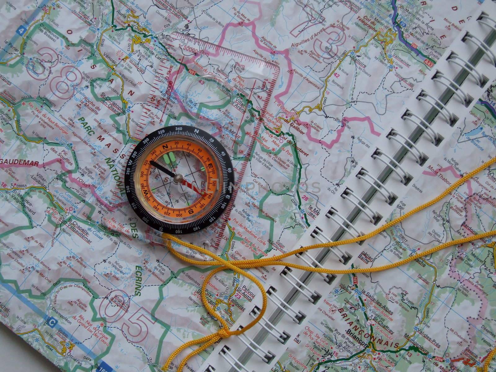 picture of compass stting on a map, as if planning a journey