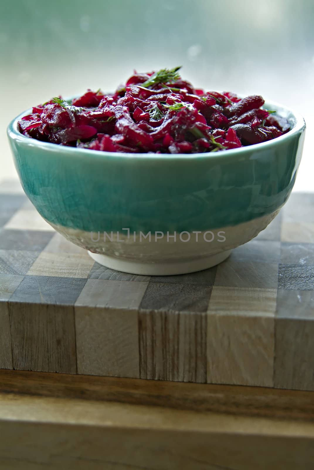 Beet salad with fresh dill in an turquoise bowl