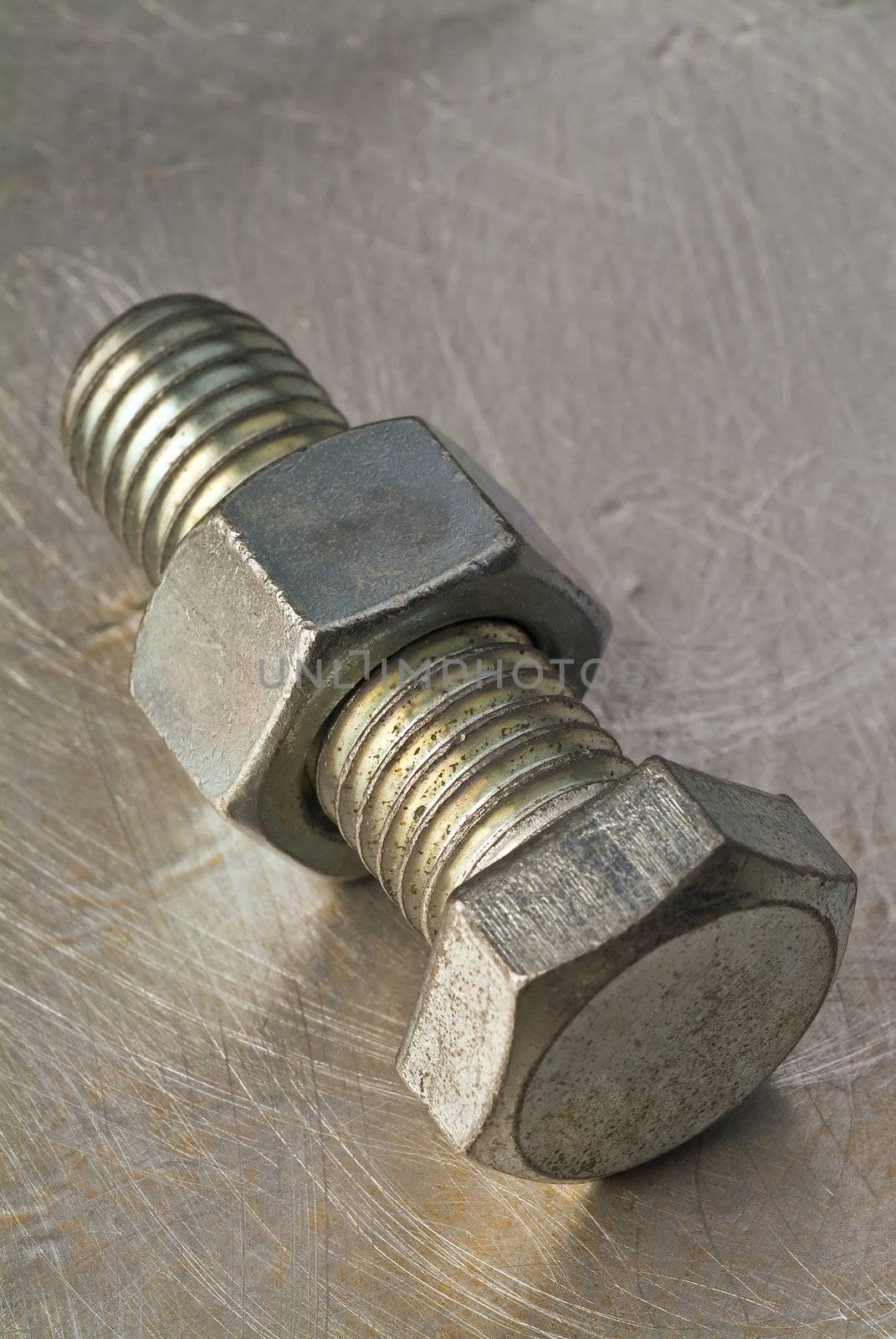bolt and nut on metallic background