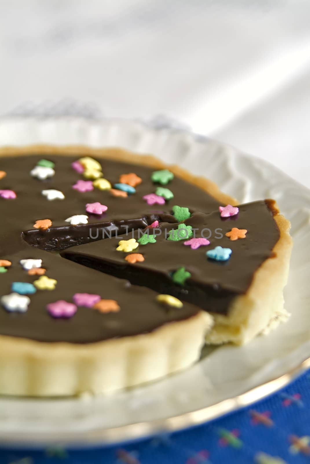 Detail of a Chocolate Tart with colorful star candies
