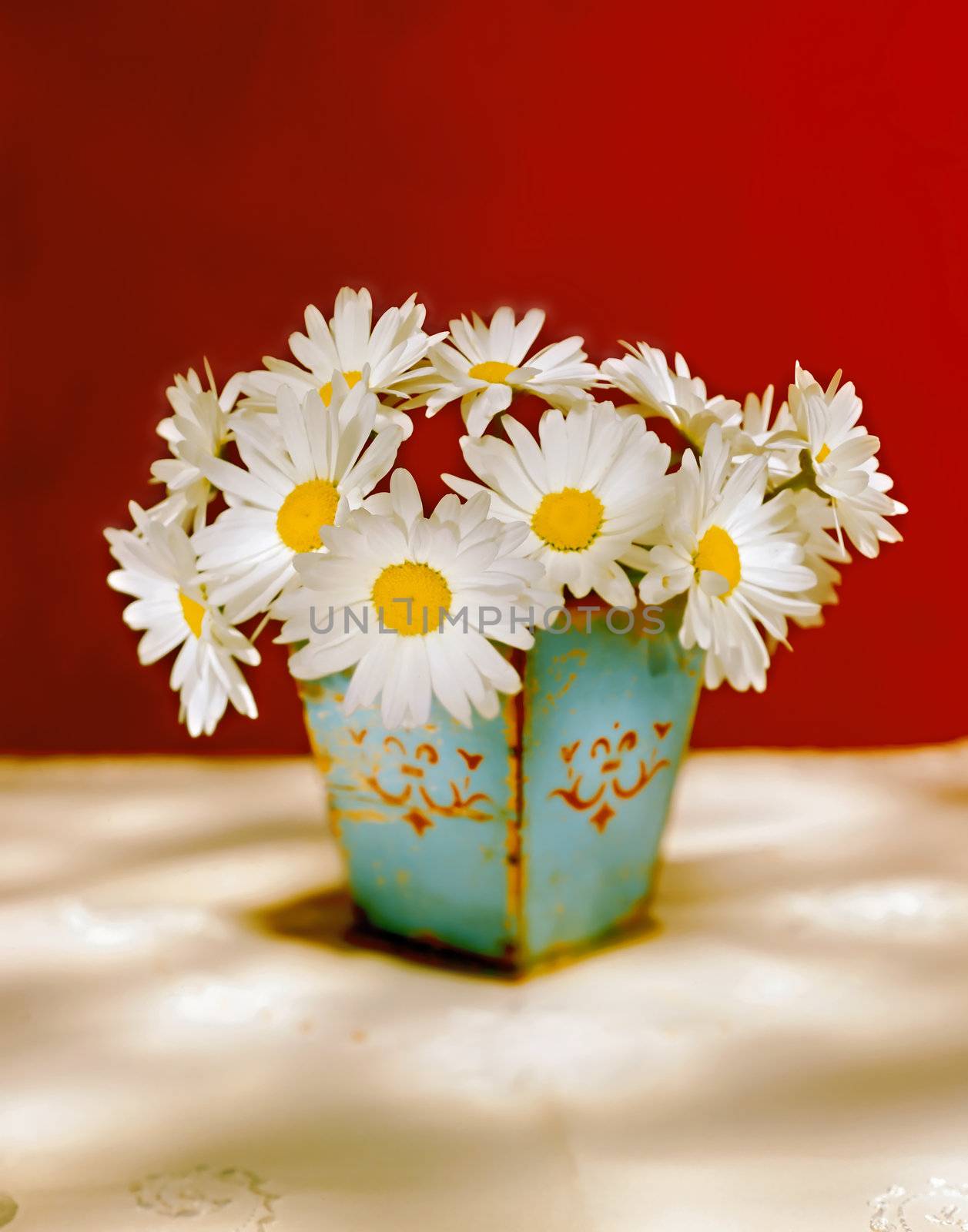 bouquet of white daisies in an old vase and red background