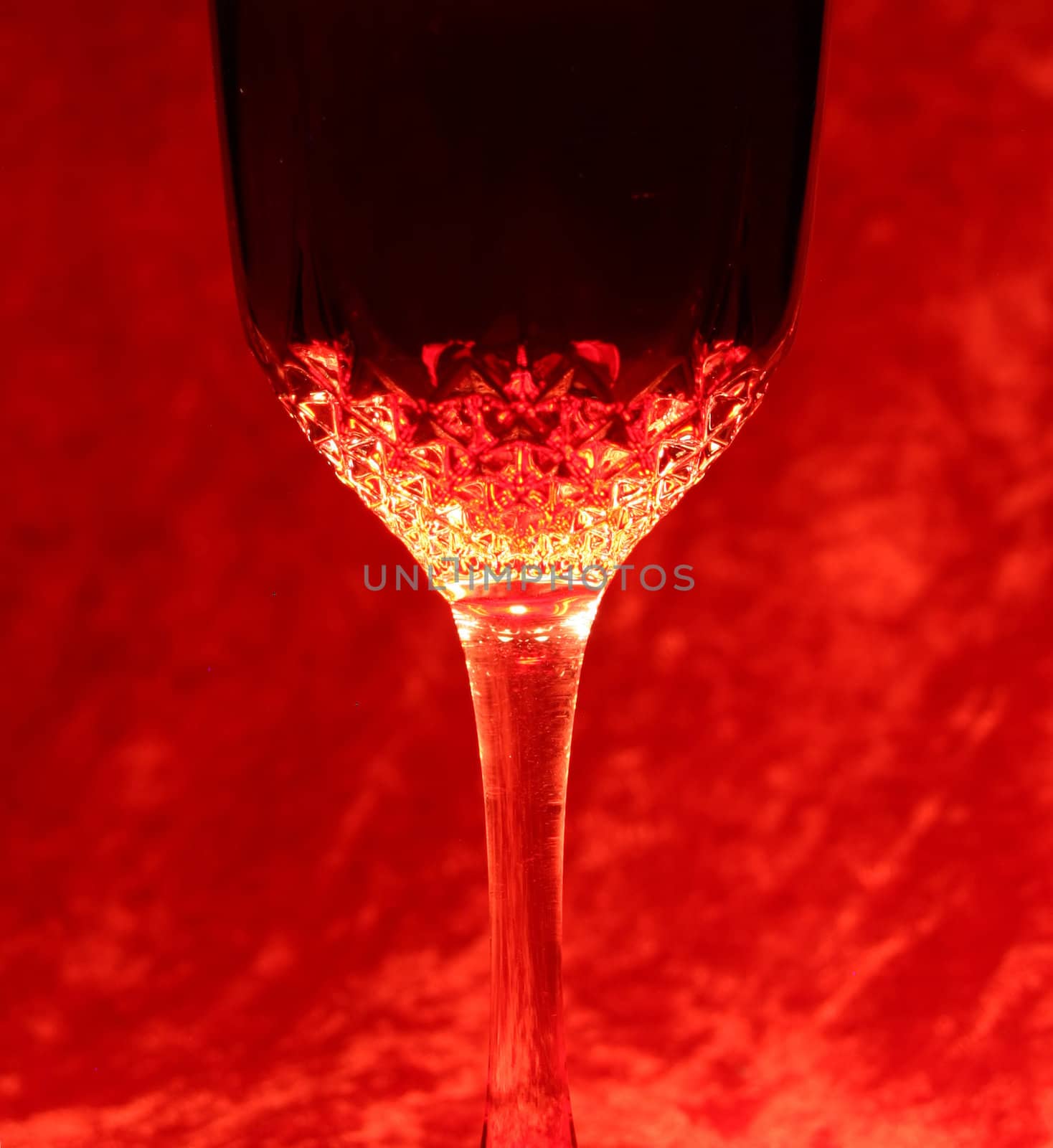port wine in glass with red background lightened from top