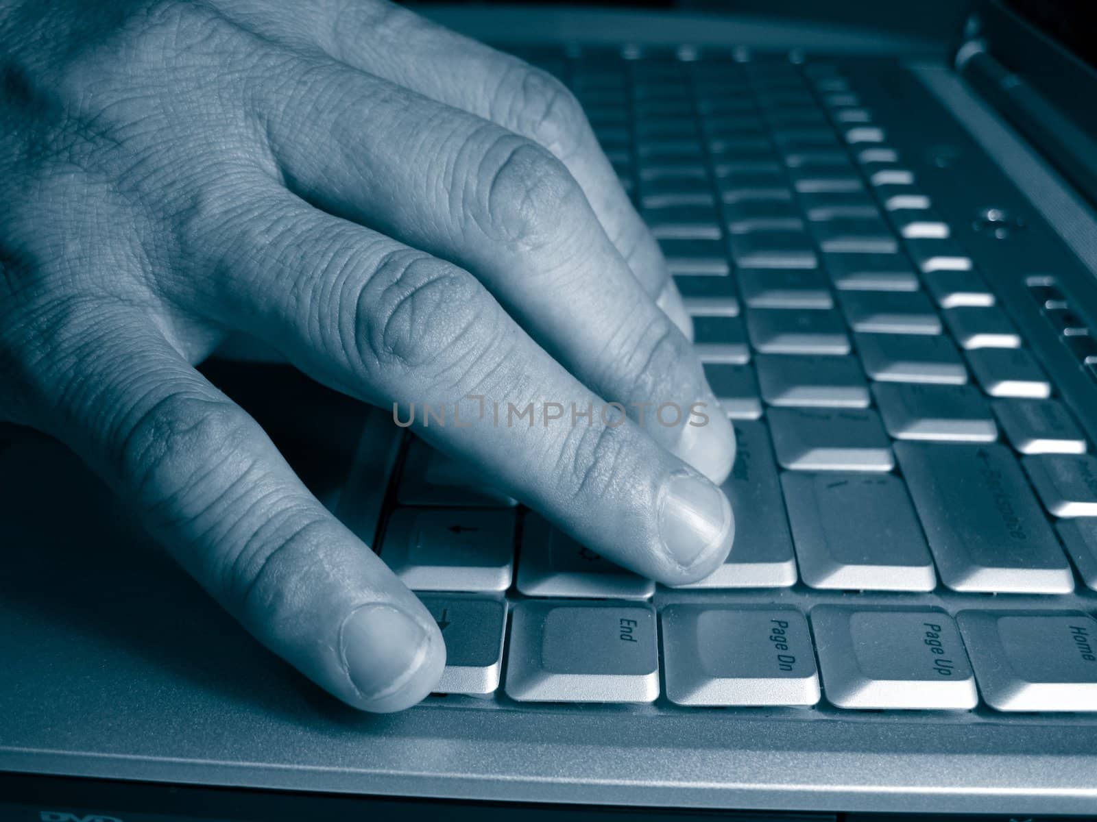 a blue monotone view for a career woman's hand is typing on a laptop, 