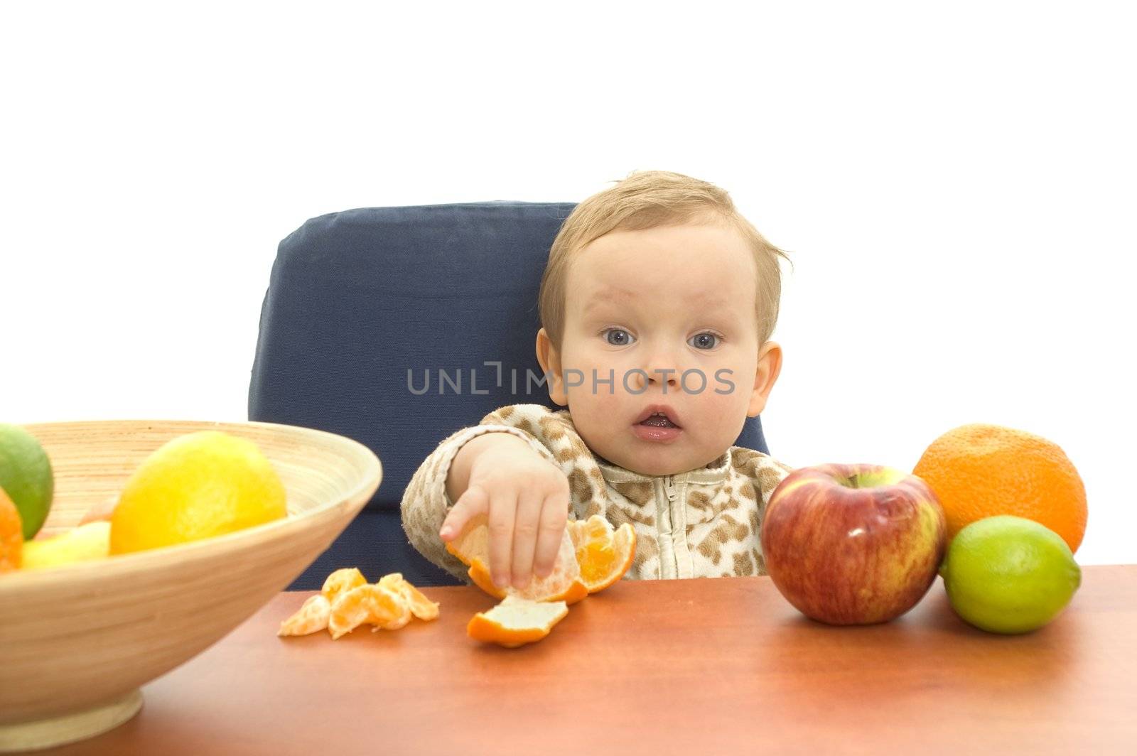 Baby and fresh fruits on table isolated background