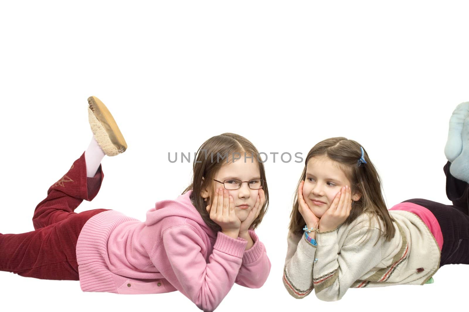 Young girls lie on floor isolated on white background