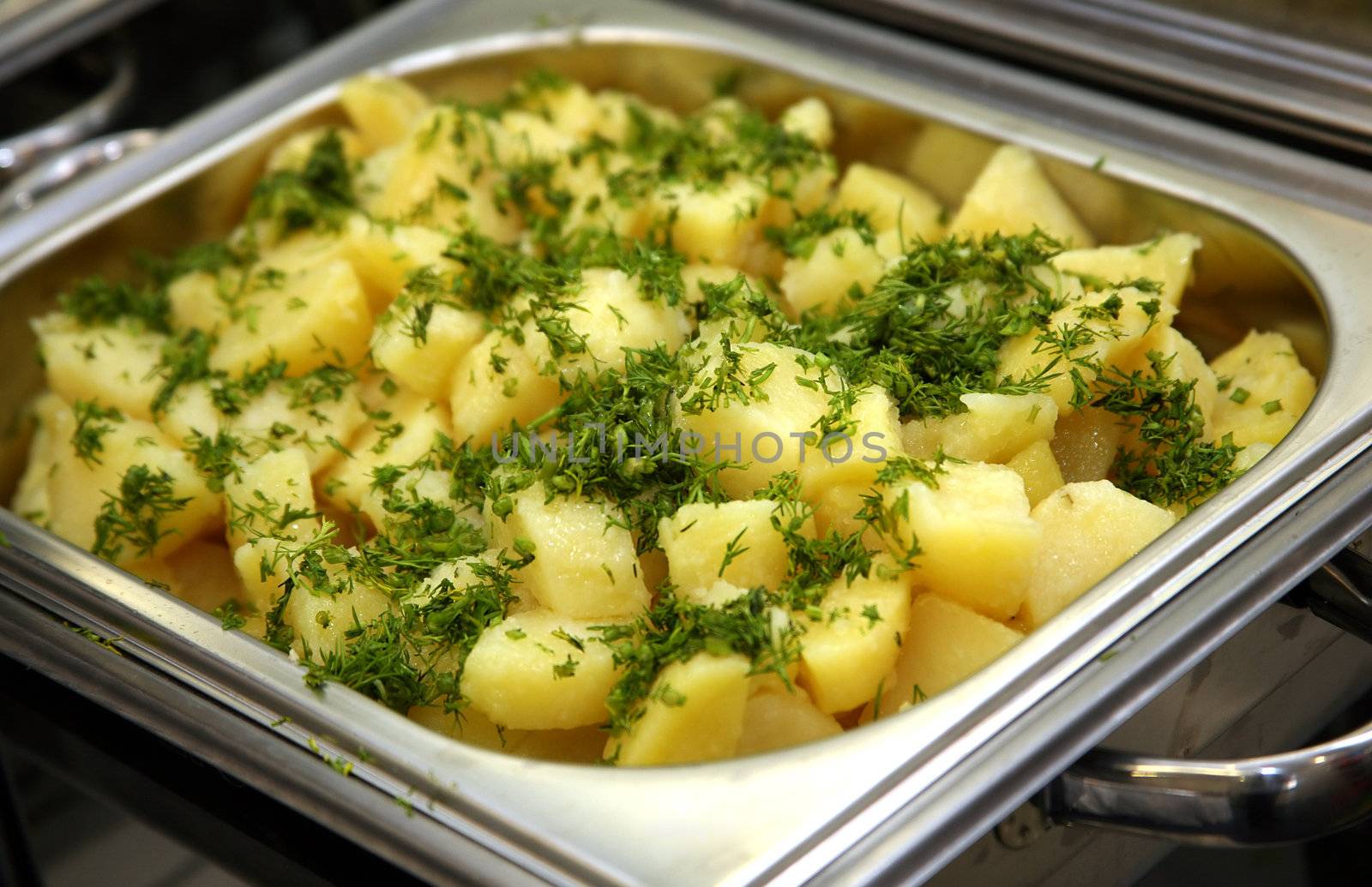 Cooked potato with fennel in a metal saucepan