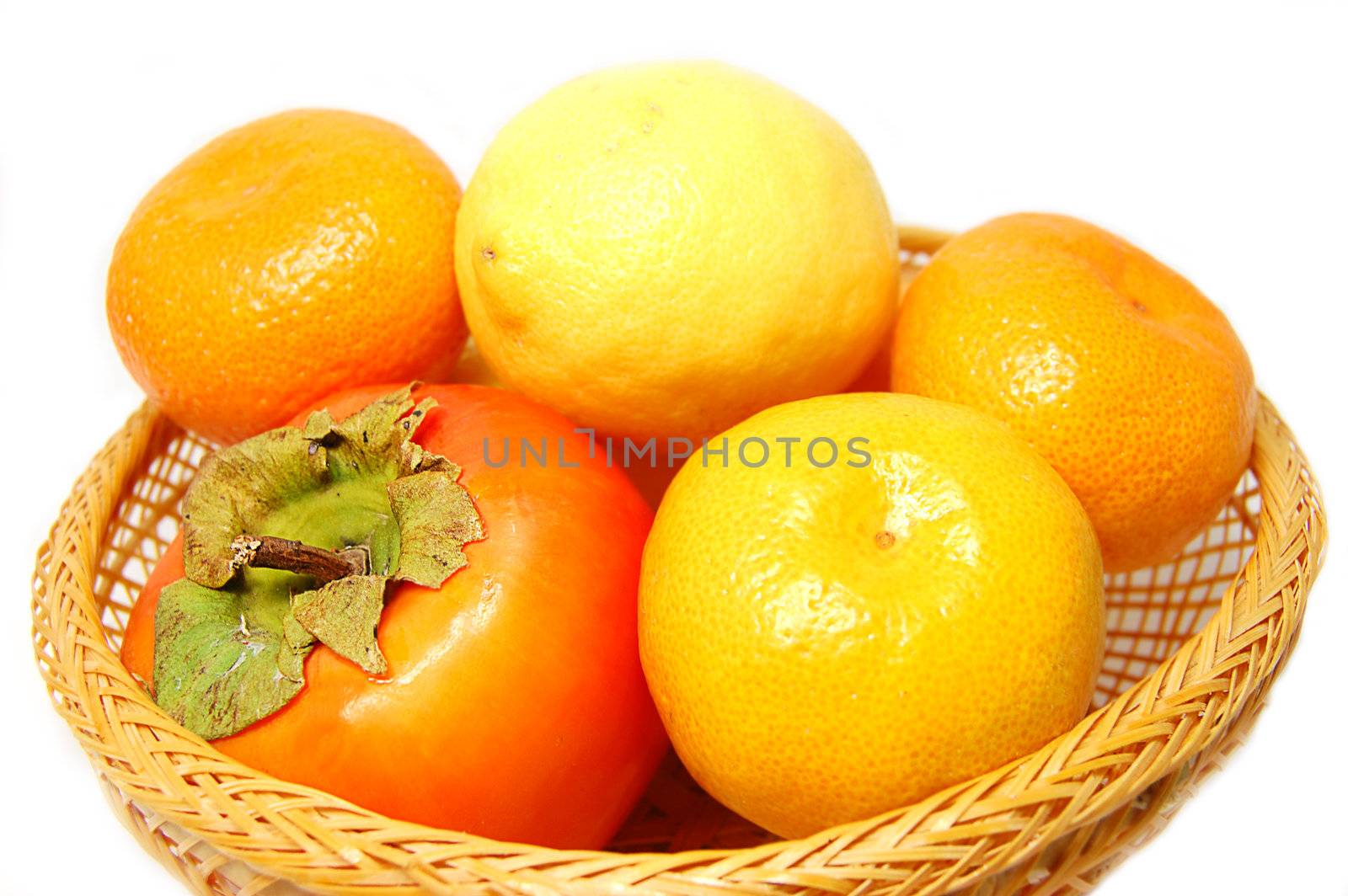 Tangerine,persimmon,lime in wattled basket