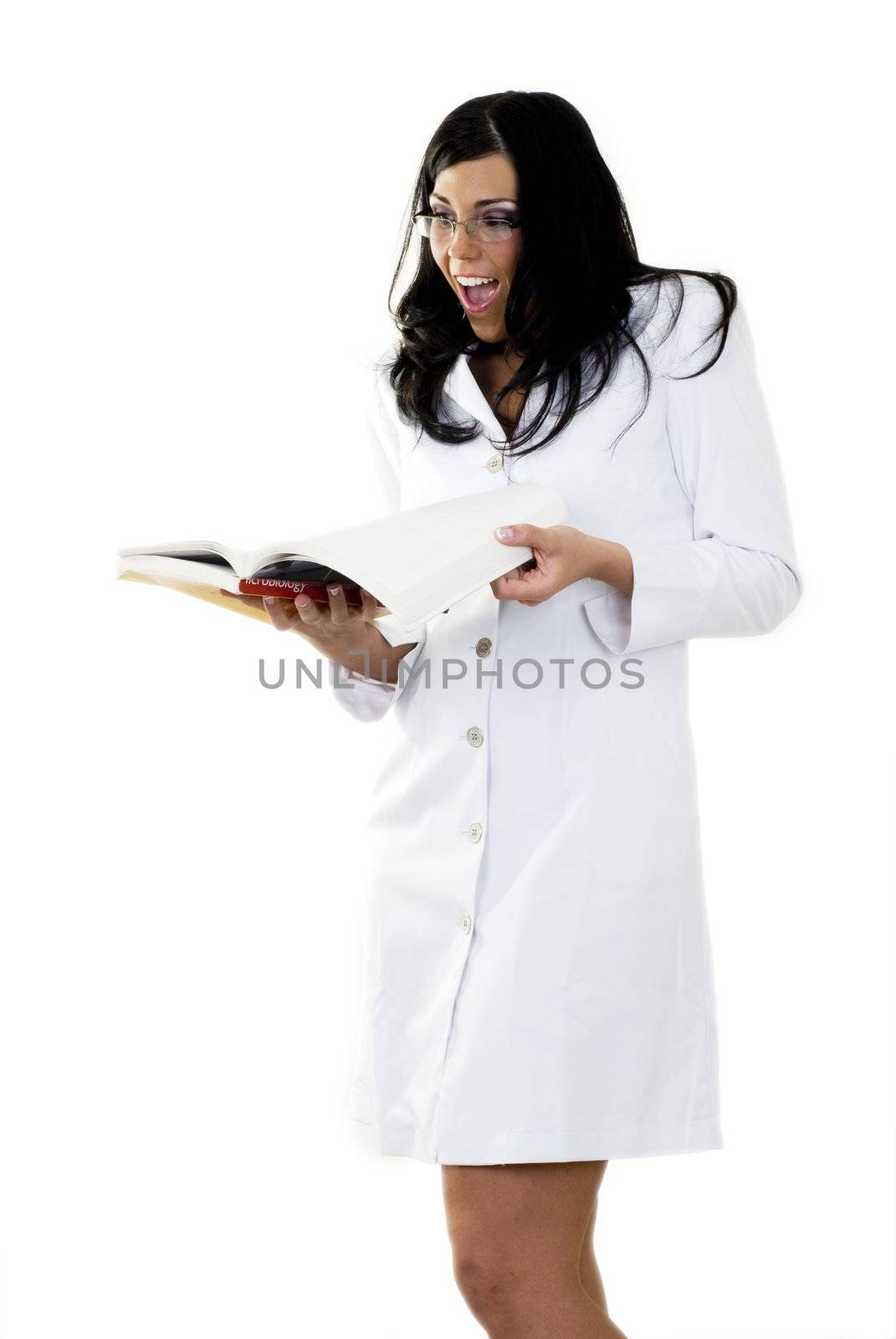 A beautiful model on a white isolated background wearing a lab coat and reading a book.