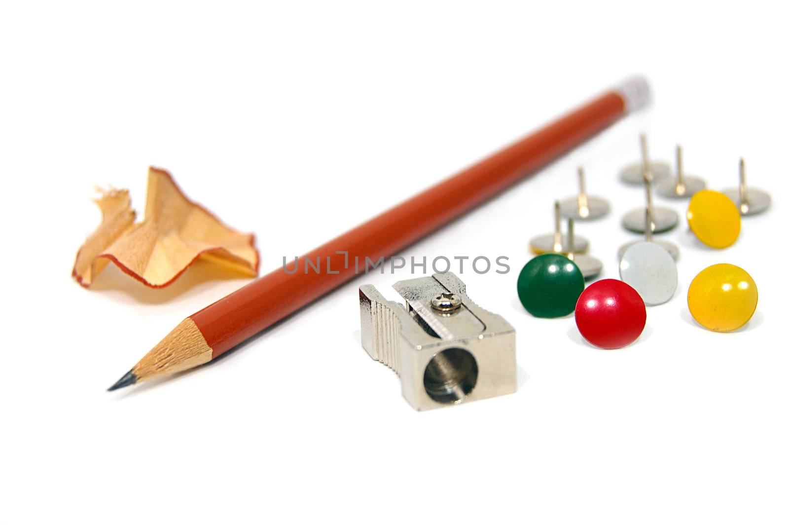 Sharpener, cuttings, pen and pins isolated on white
