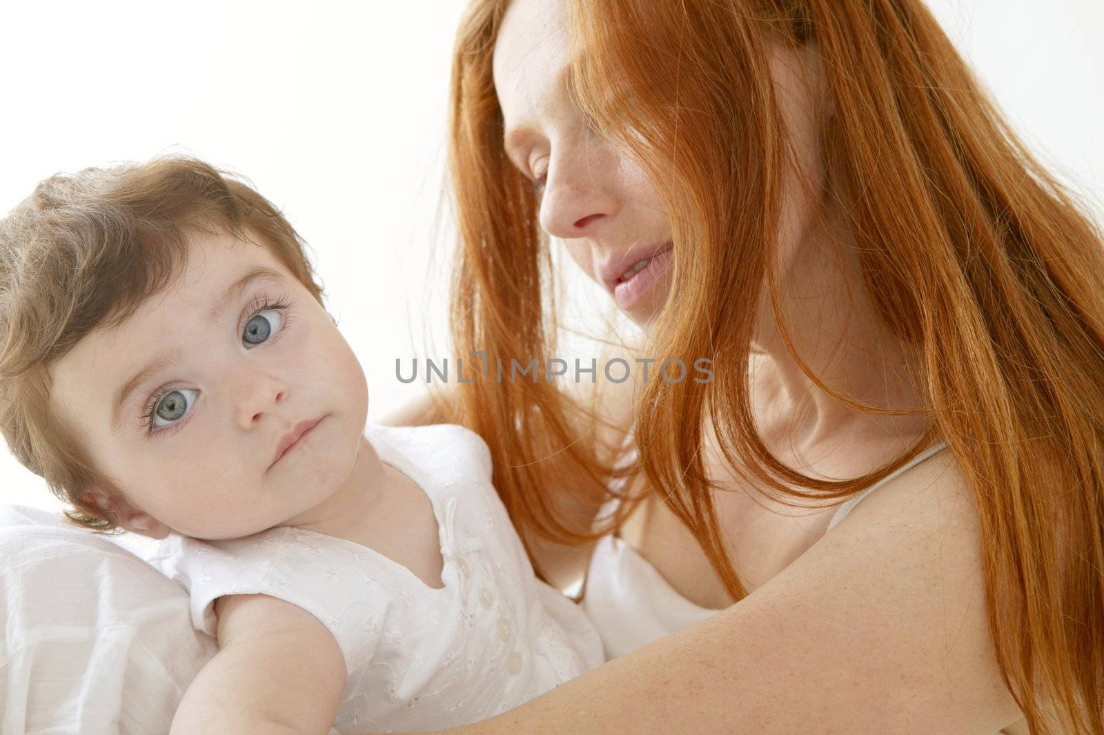 baby and mom in love hug over white studio background