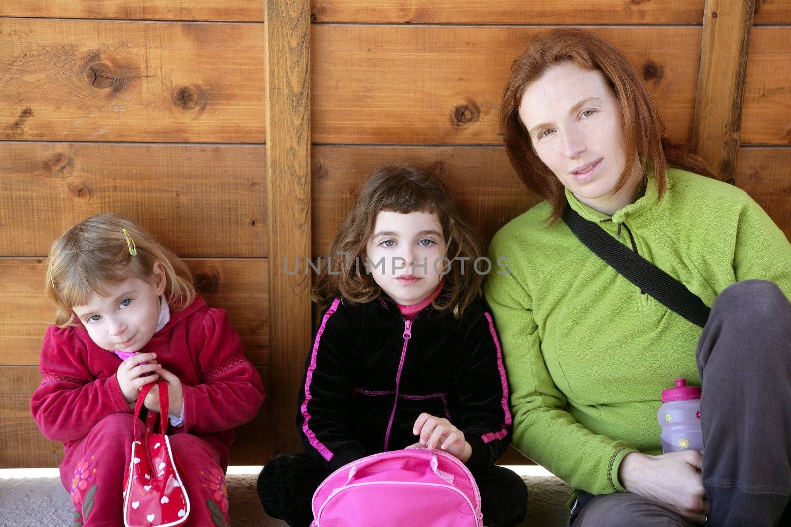 Mother and two daughter sister sit by lunamarina