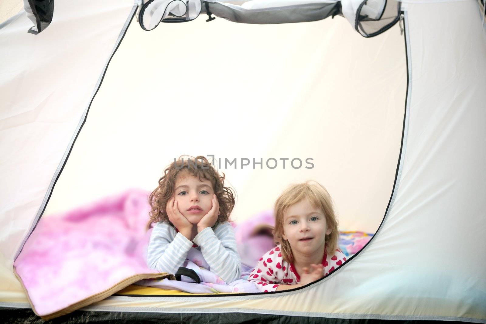 Camping tent vacation with two little beautiful girls in nature