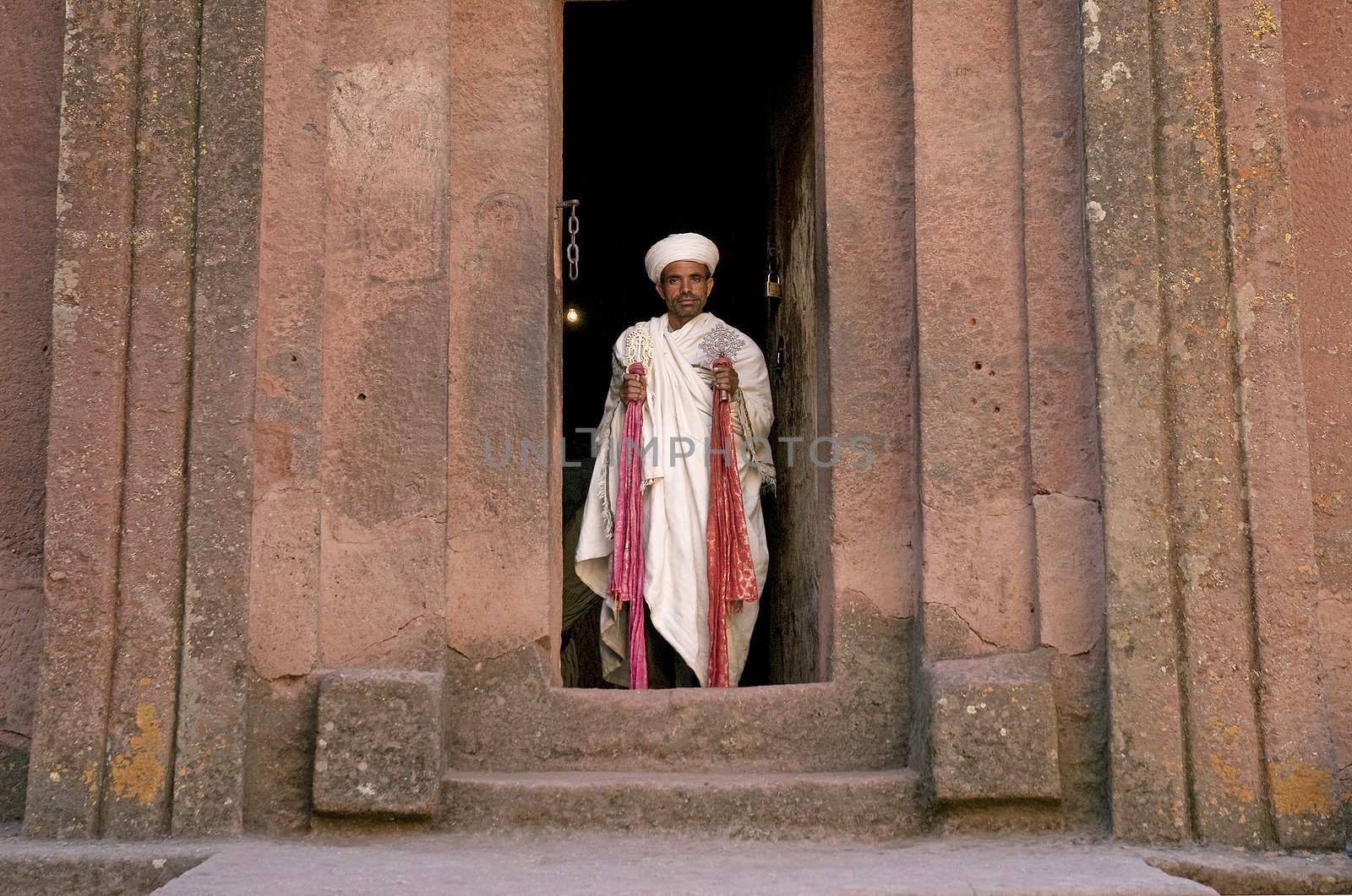 priest at ancient rock hewn churches of lalibela ethiopia by jackmalipan