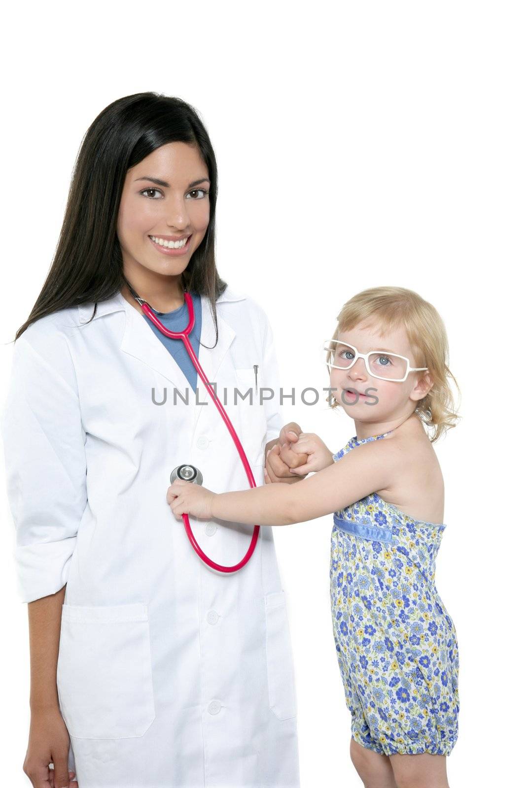 Brunette pediatric doctor with blond little girl on medical exam