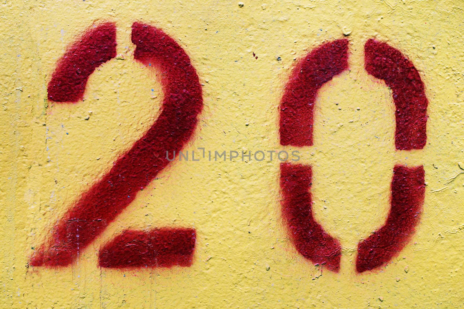 Number 20 painted with red paint and a stencil.