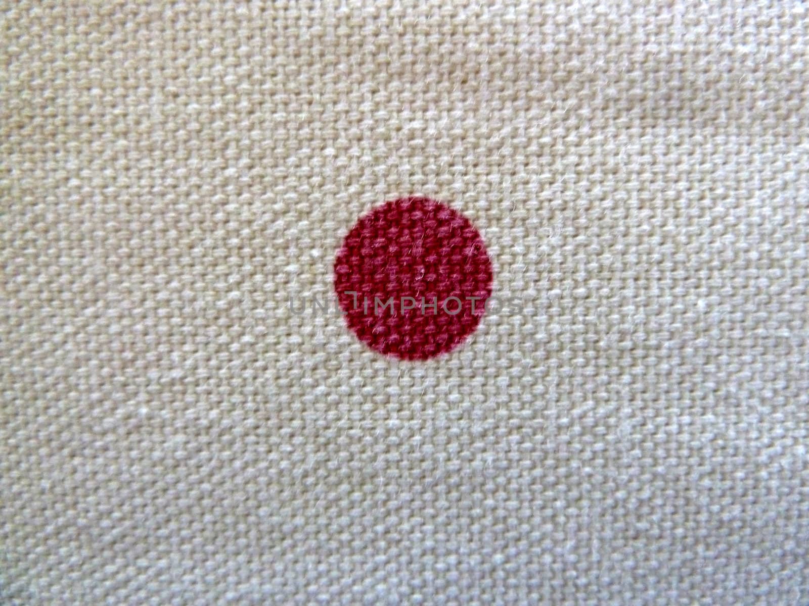 single red spot on white fabric