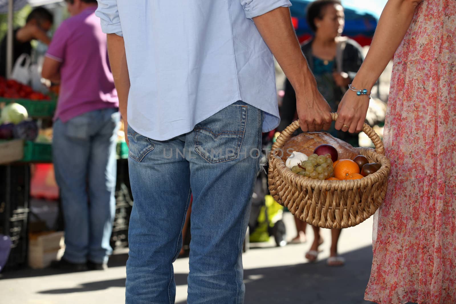 young couple at market buying fruits