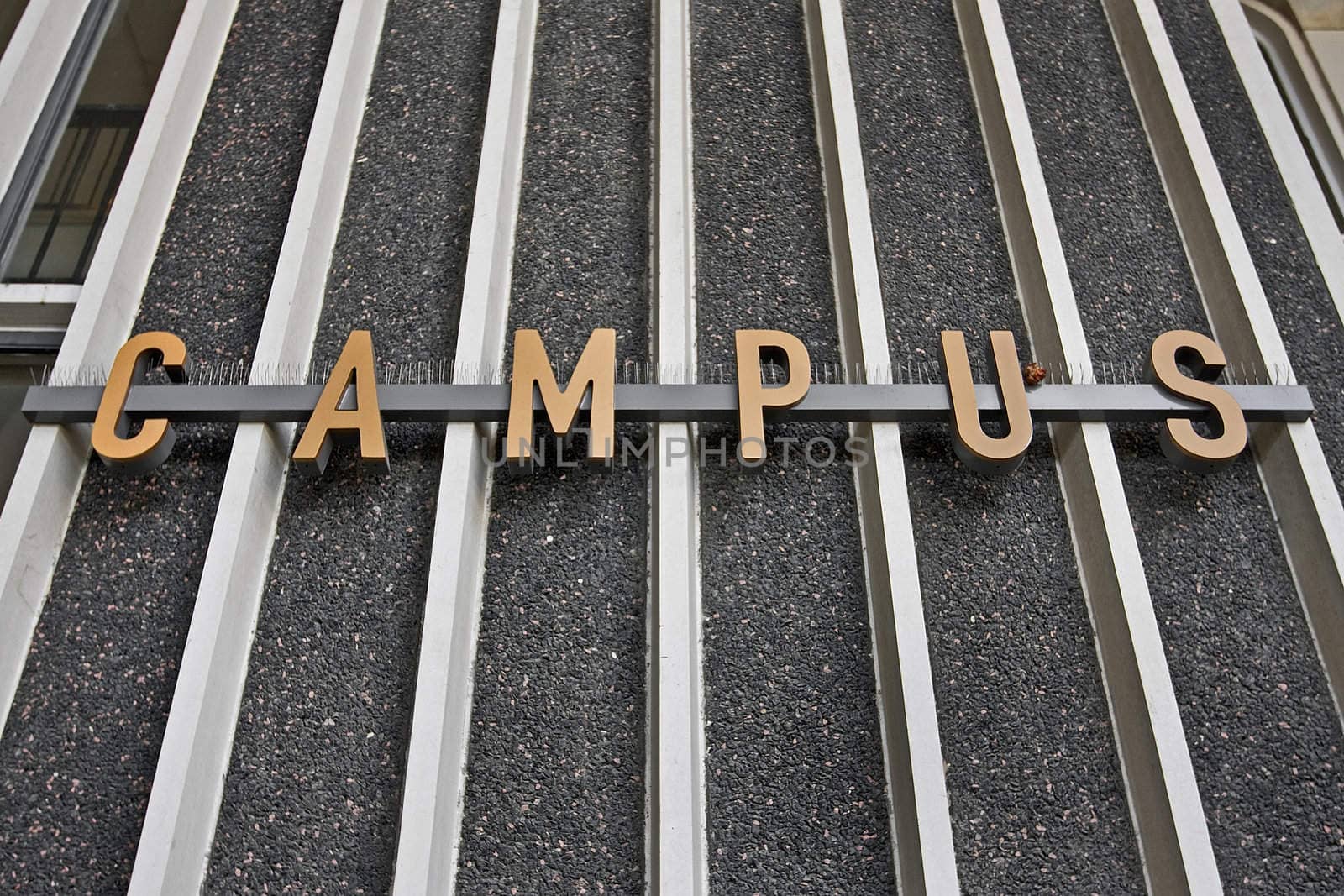 campus sign on the steel rails and concrete wall