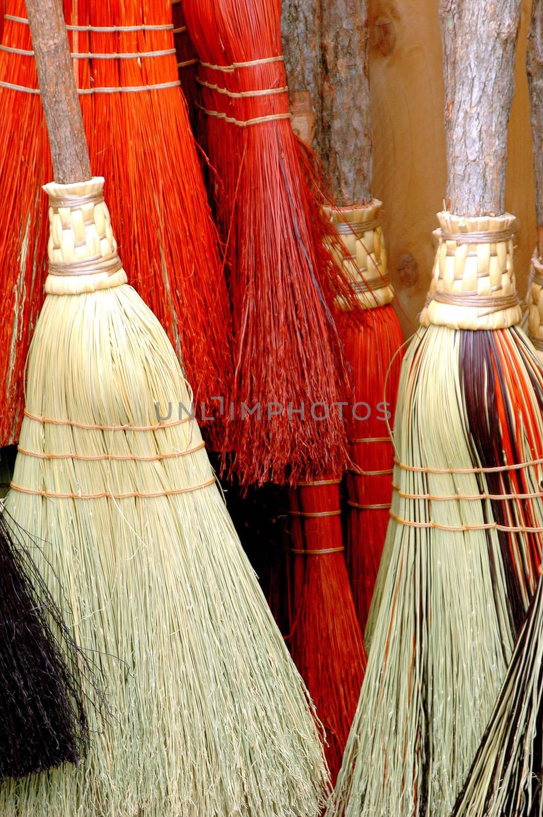 Colorful brooms on display indoors.