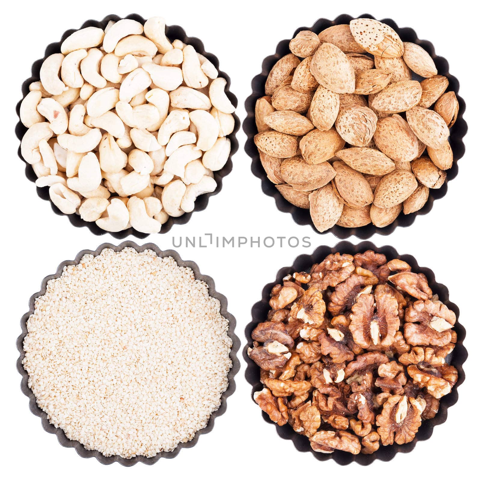 Assorted nuts in a bowl with wavy edges, isolated on white