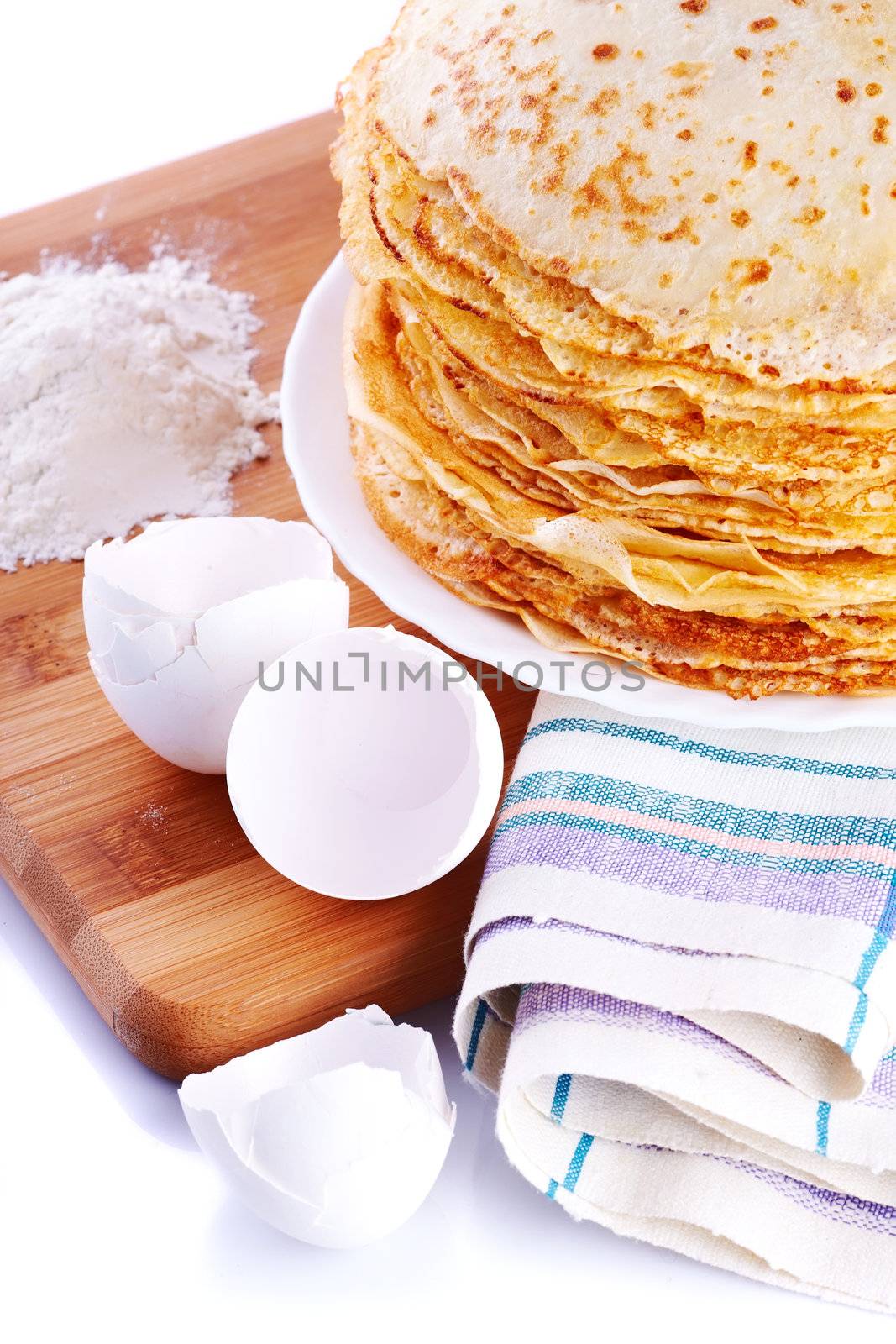 Ingredients of pancakes. Pancakes on a plate. Shell from eggs and pancakes.