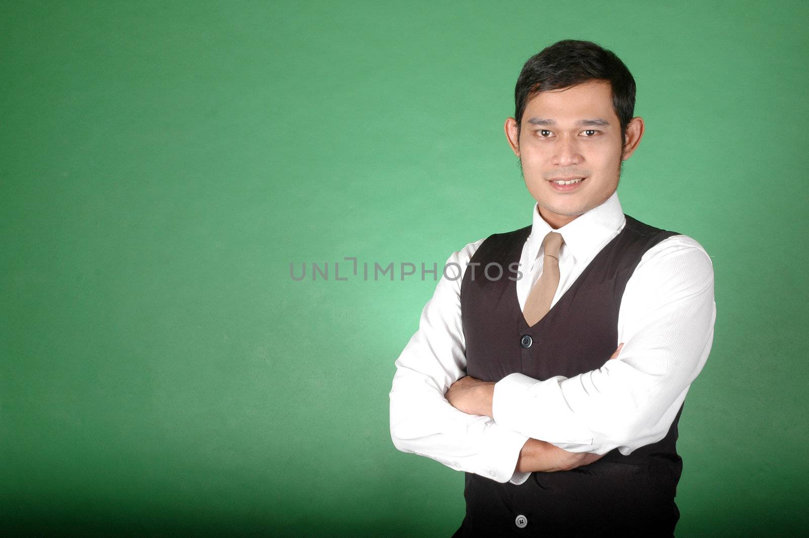 portrait of asian young man against green background