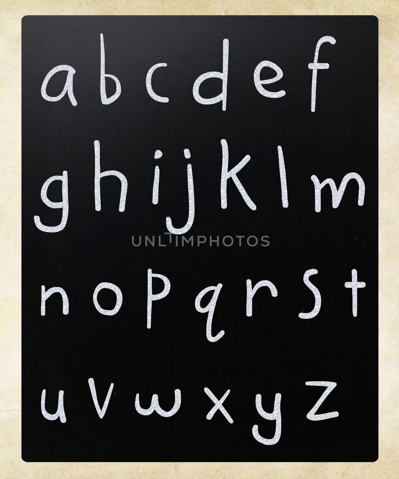 Complete english alphabet handwritten with white chalk on a blackboard