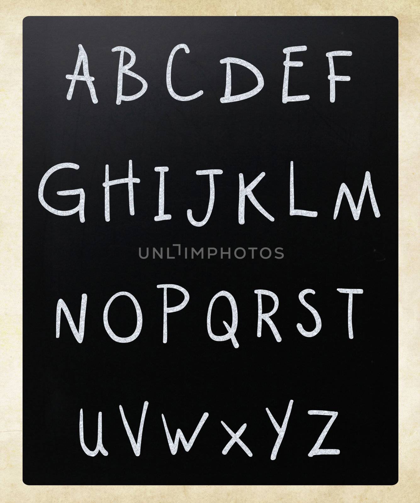 Complete english alphabet handwritten with white chalk on a blackboard